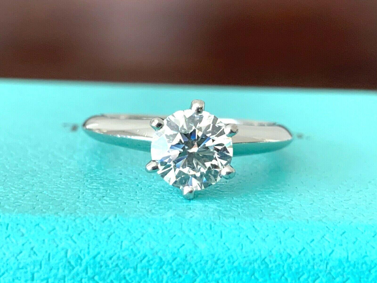 Being offered for your consideration is a like new Tiffany & Co Platinum and Diamond .91 carat natural round engagement ring set in the classic 6 prong setting.  This diamond shows SUPER large and fiery.   It has a very wide and shallow diamond