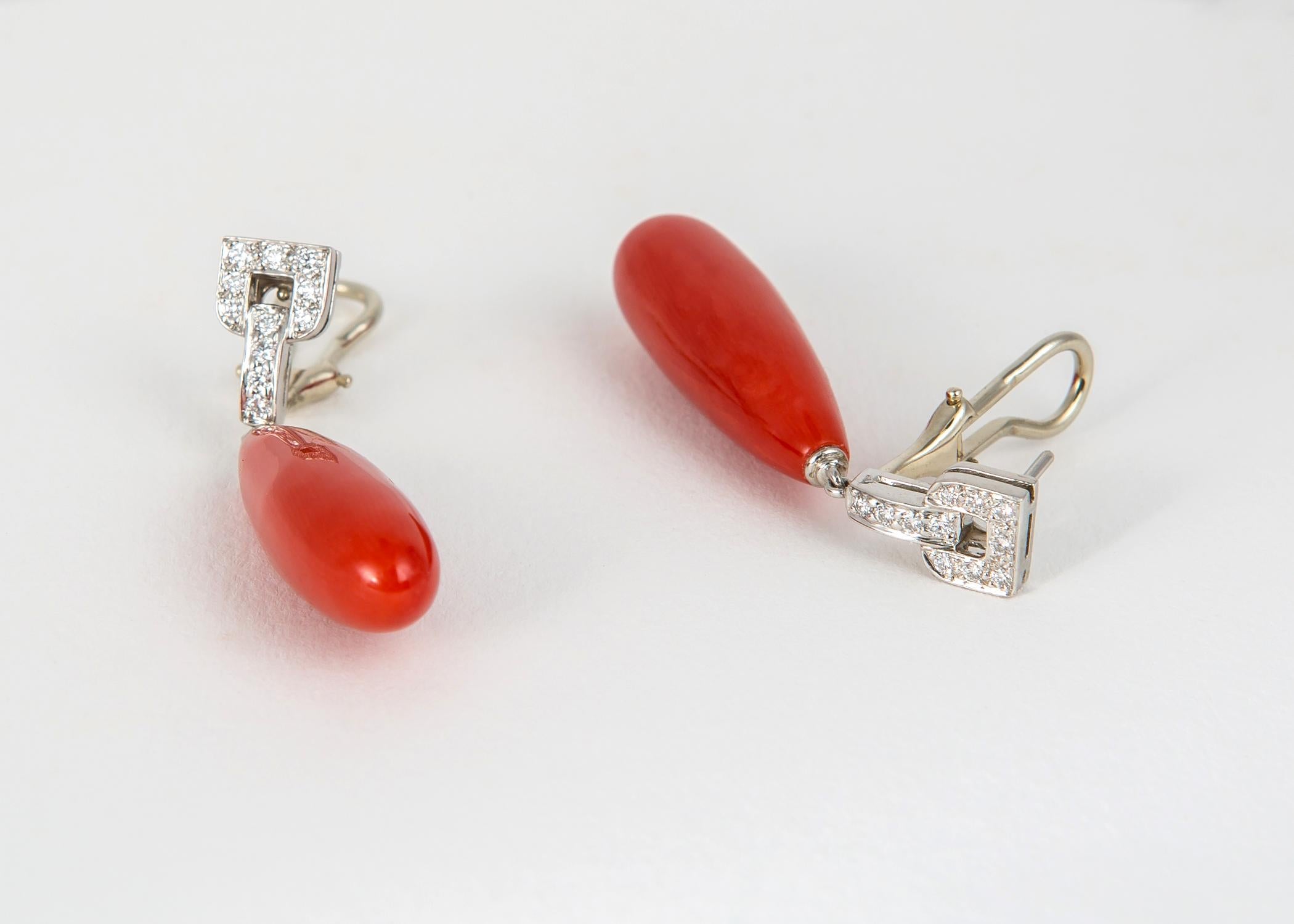 Tiffany & Co. showcases a truly exceptional matched pair of vivid dark orange coral drops with the simple elegance of platinum and diamonds. 1 3/4 inches. A collectors item.