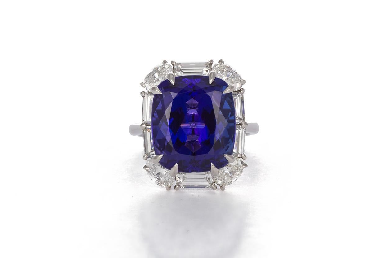 We are is pleased to offer this Authentic Tiffany & Co. Platinum, Diamond and Tanzanite Fashion Ring. This incredible ring features a 15.71ct cushion cut Tanzanite center stone accented by 3.70ctw G/VS1 Oval and Baguette Cut Diamonds all set in .950