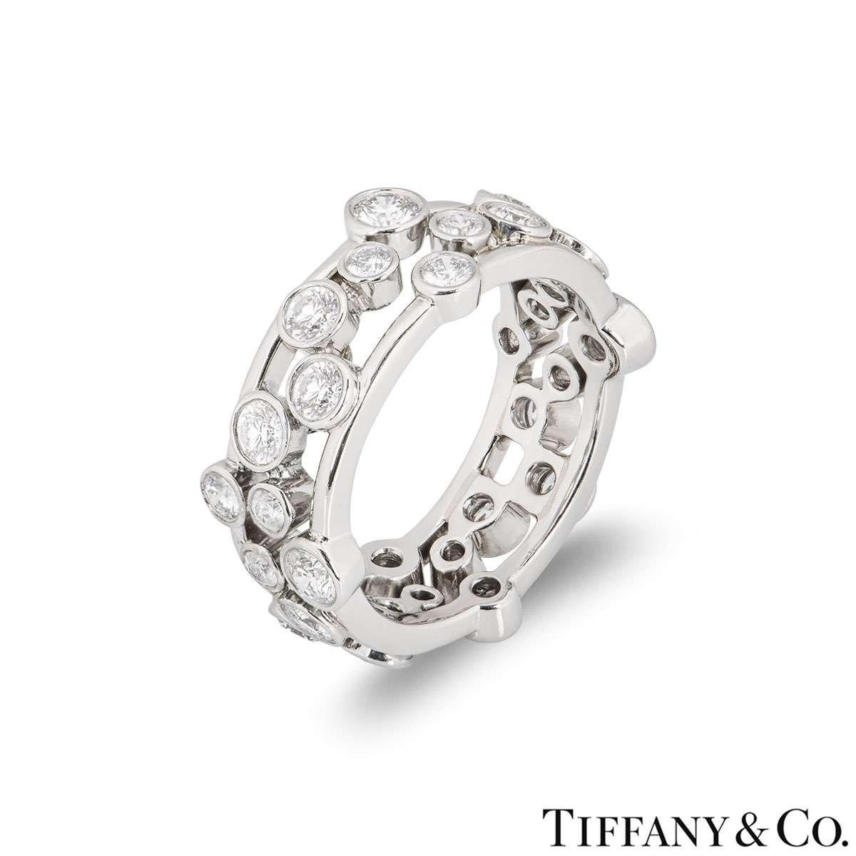A platinum diamond ring from the Bubble collection by Tiffany & Co. The ring is set with round brilliant cut rubover set diamonds varying in size. The diamonds have an approximate total weight of 1.60ct. The ring measures 8mm in width and is a size