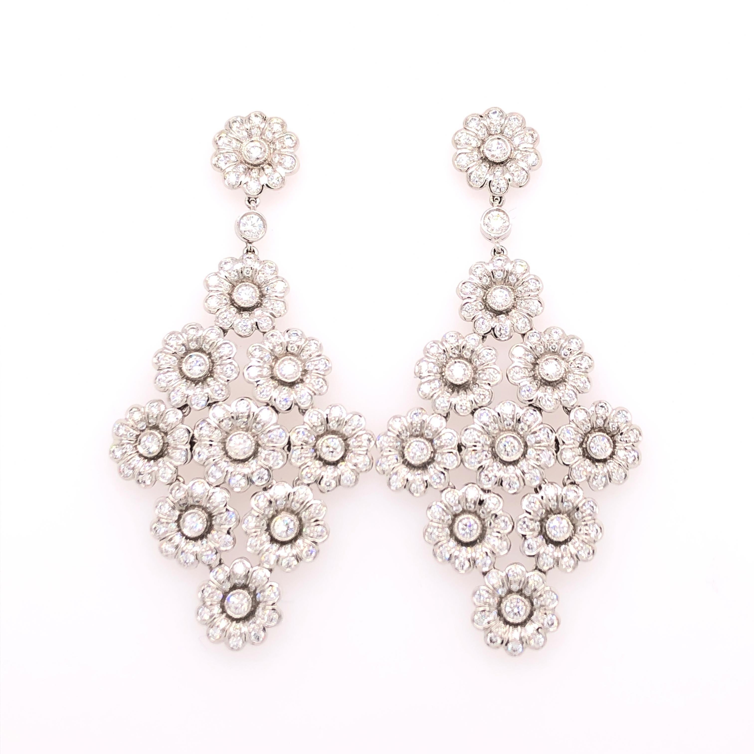 This absolutely stunning pair of Tiffany & Co. floral motif dangle earrings are made from platinum and 4.15 CTW of diamonds. Nine flowers create a diamond shape that dangles from the 10th flower. Post back, these earrings are made for pierced ears.