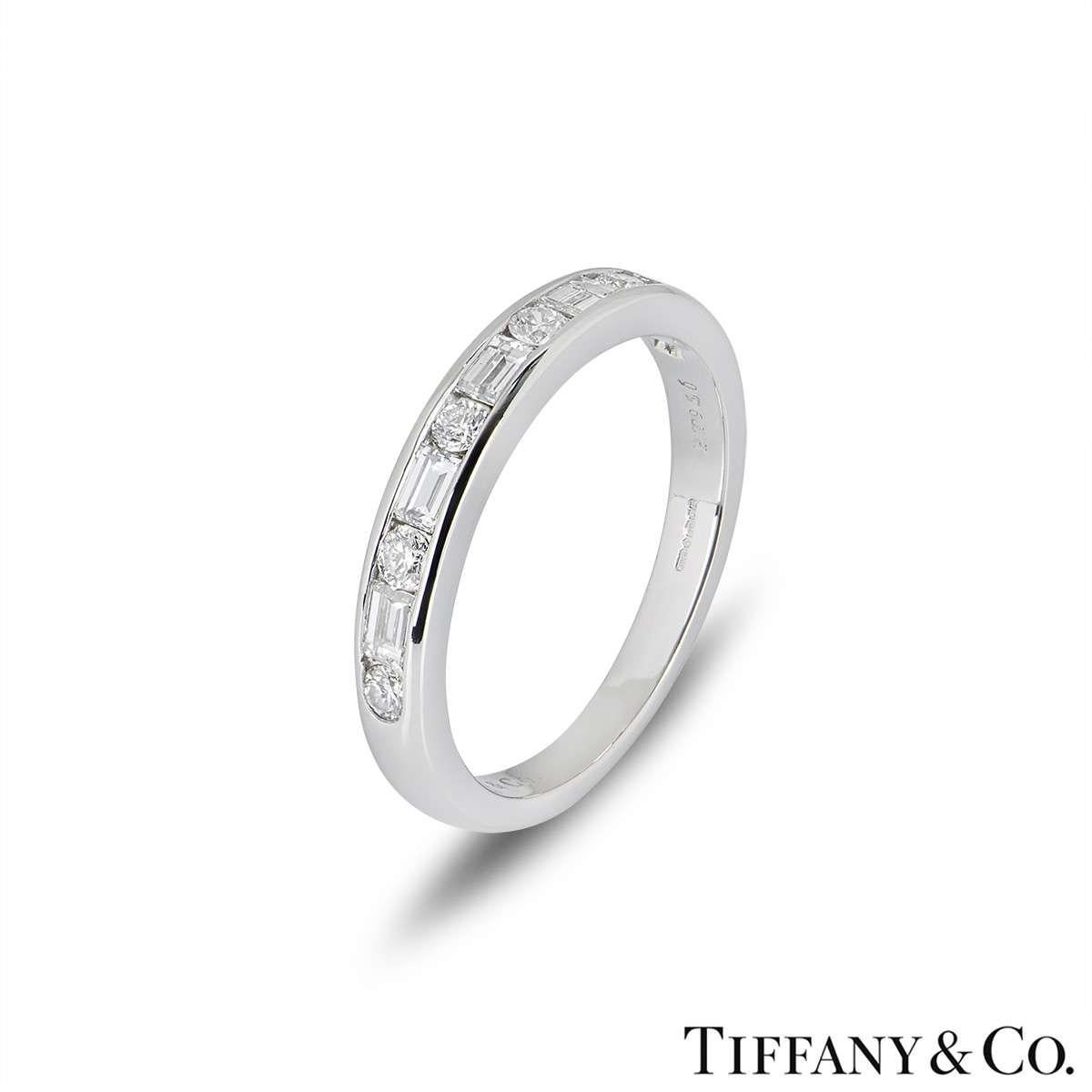 A beautiful platinum diamond band by Tiffany & Co. The ring is set with 6 round brilliant cut diamonds and 5 baguette cut diamonds totalling 0.66ct. The ring is currently a size UK O - EU 55 - US 7.25 but can be adjusted for a perfect fit. The ring