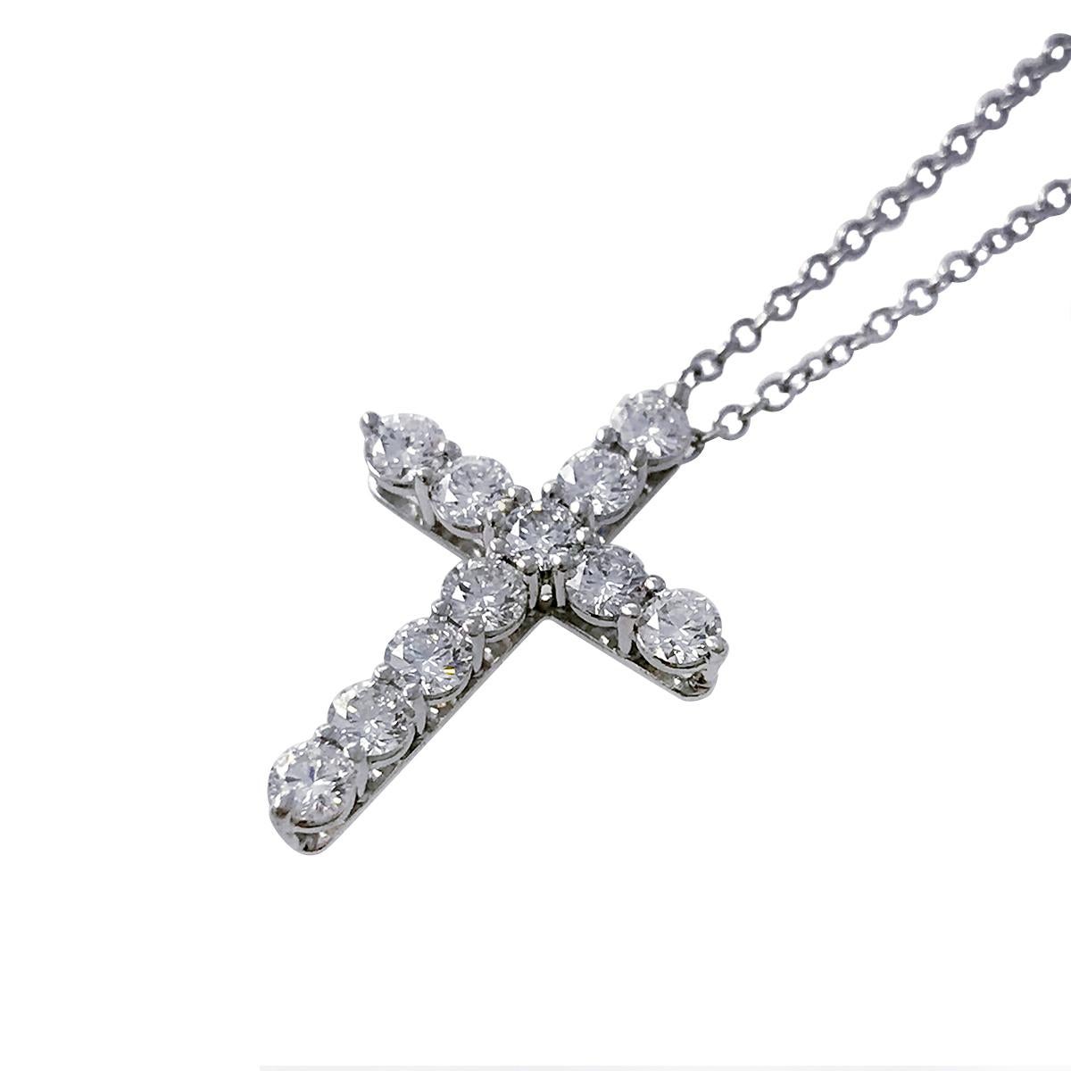 Tiffany & Co. platinum diamond cross pendant necklace adorned with eleven round brilliant cut diamonds. The diamonds are prong-set in basket-style mountings that allow light to flow through the diamonds for ultimate sparkle and brilliance. Diamonds