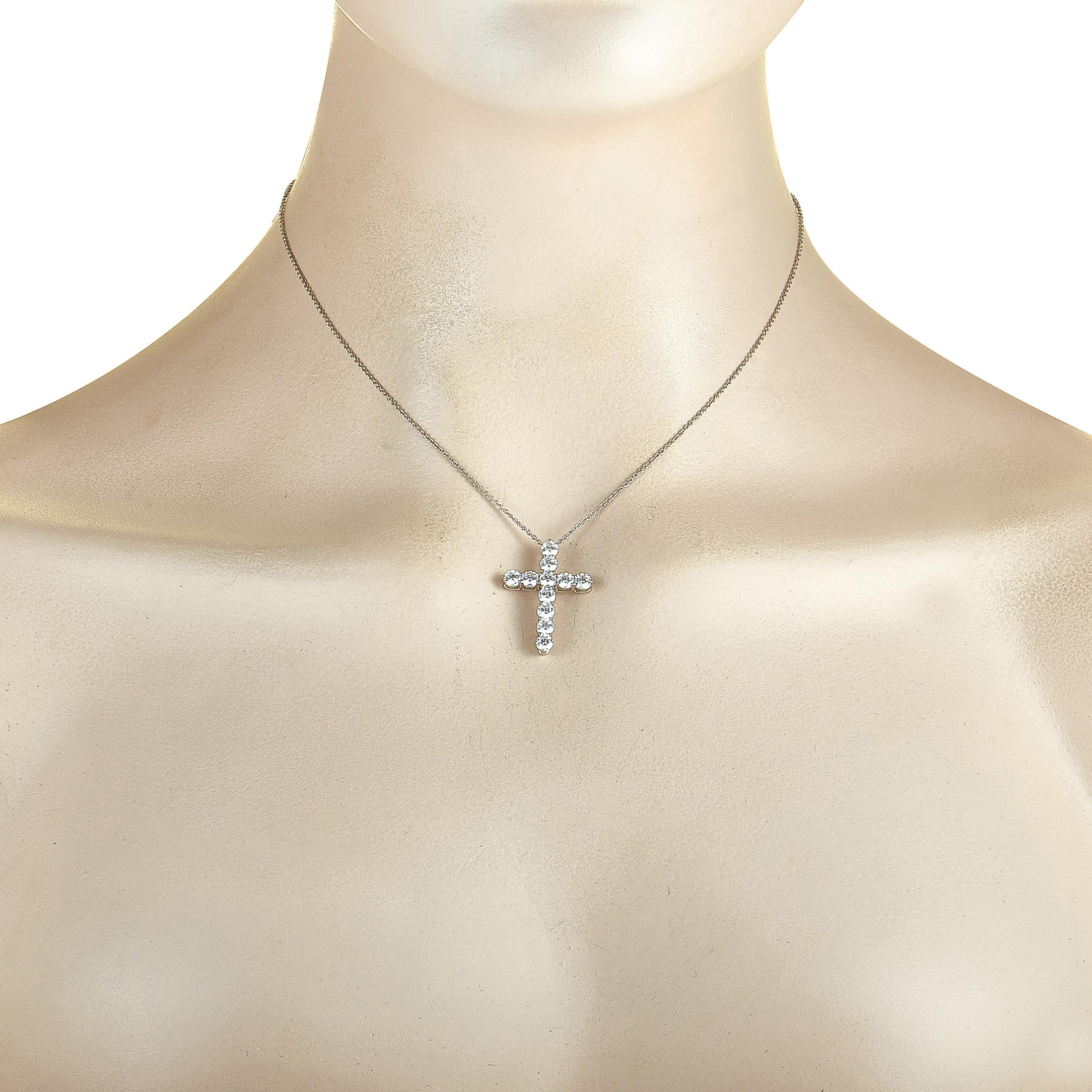 This Tiffany & Co. necklace is crafted from platinum, featuring a 16” chain with spring ring closure and a cross pendant that measures 1” in length and 0.75” in width. The necklace is set with a total of 1.71 carats of diamonds that boast grade E