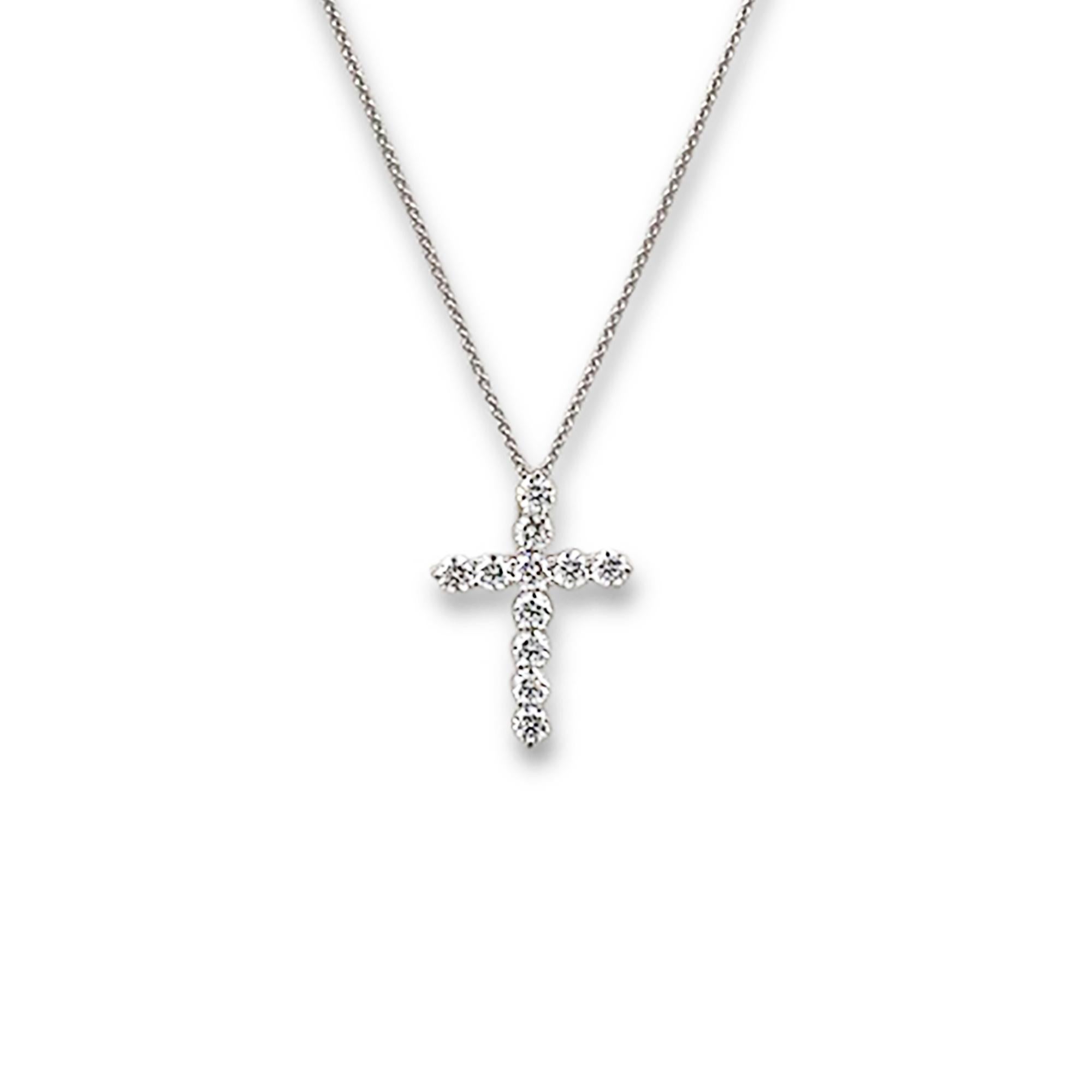 Authentic Tiffany & Co. large cross pendant crafted in platinum and set with 11 glittering round brilliant diamonds (E-F color, VS1 clarity) of approximately 1.71 carats total weight.  The pendant is situated on a delicate platinum chain measuring