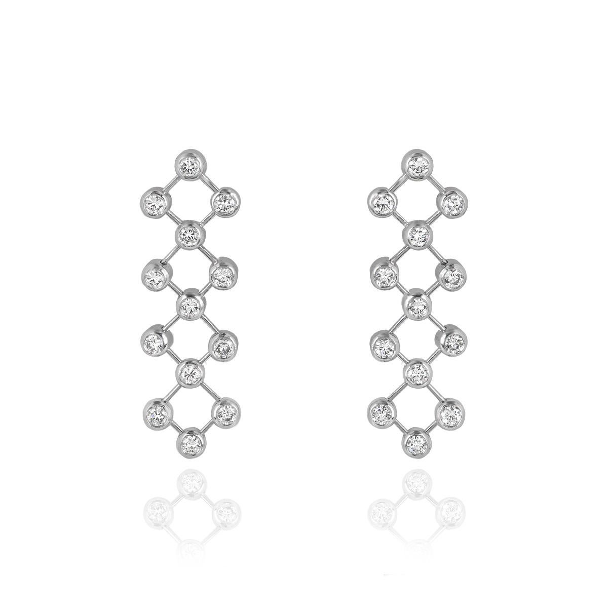 A stunning pair of platinum diamond drop earrings by Tiffany & Co. The earrings are set with round brilliant cut diamonds in a rubover setting joined together by moving flexi bars. The 26 diamonds have an approximate total weight of 1.04ct. The