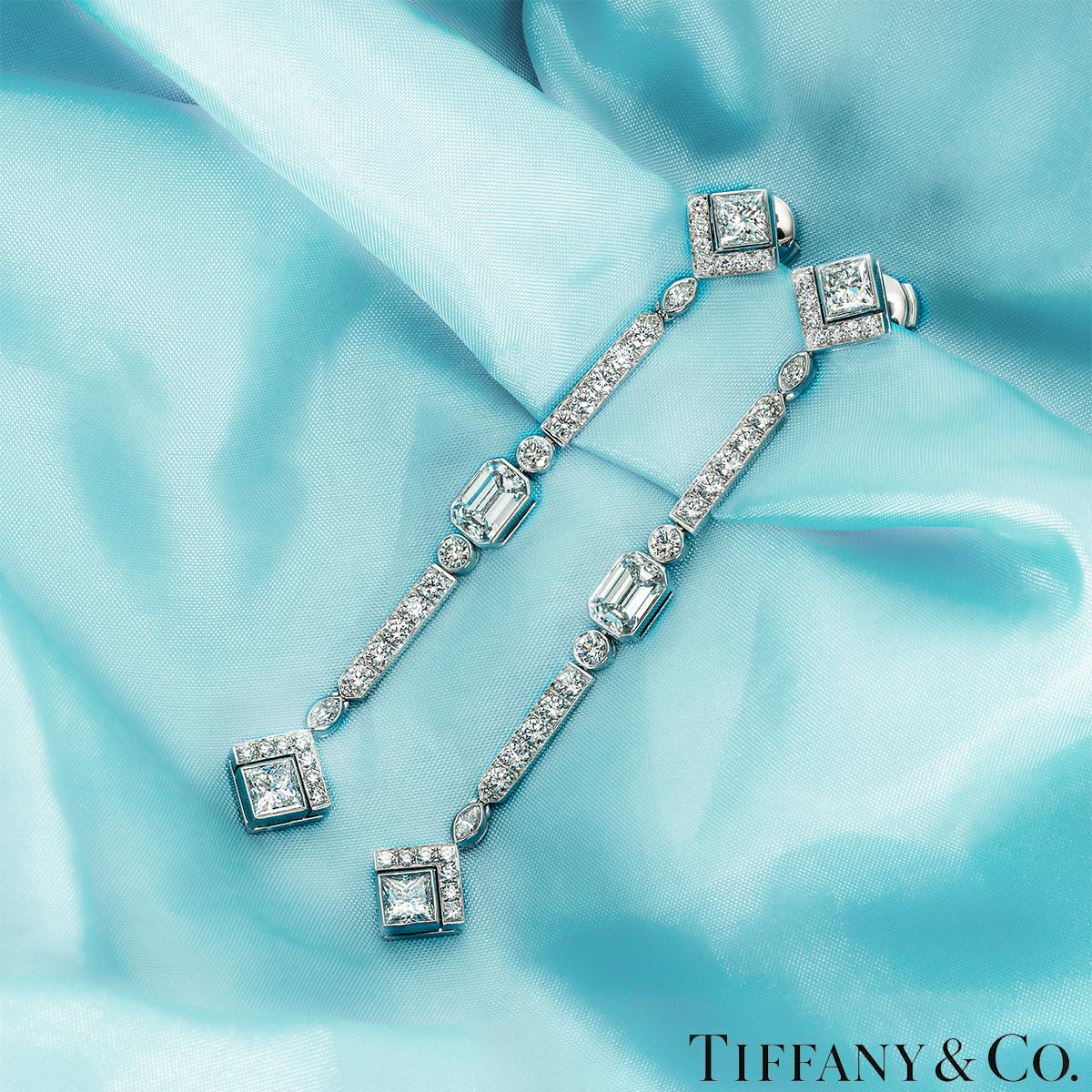 A bespoke pair of platinum diamond drop earrings by Tiffany & Co. Both earrings start with a square cut diamond encased at the bottom by 7 round brilliant cut diamonds, followed by a bezel set marquise cut diamond and a row of 5 round brilliant cut