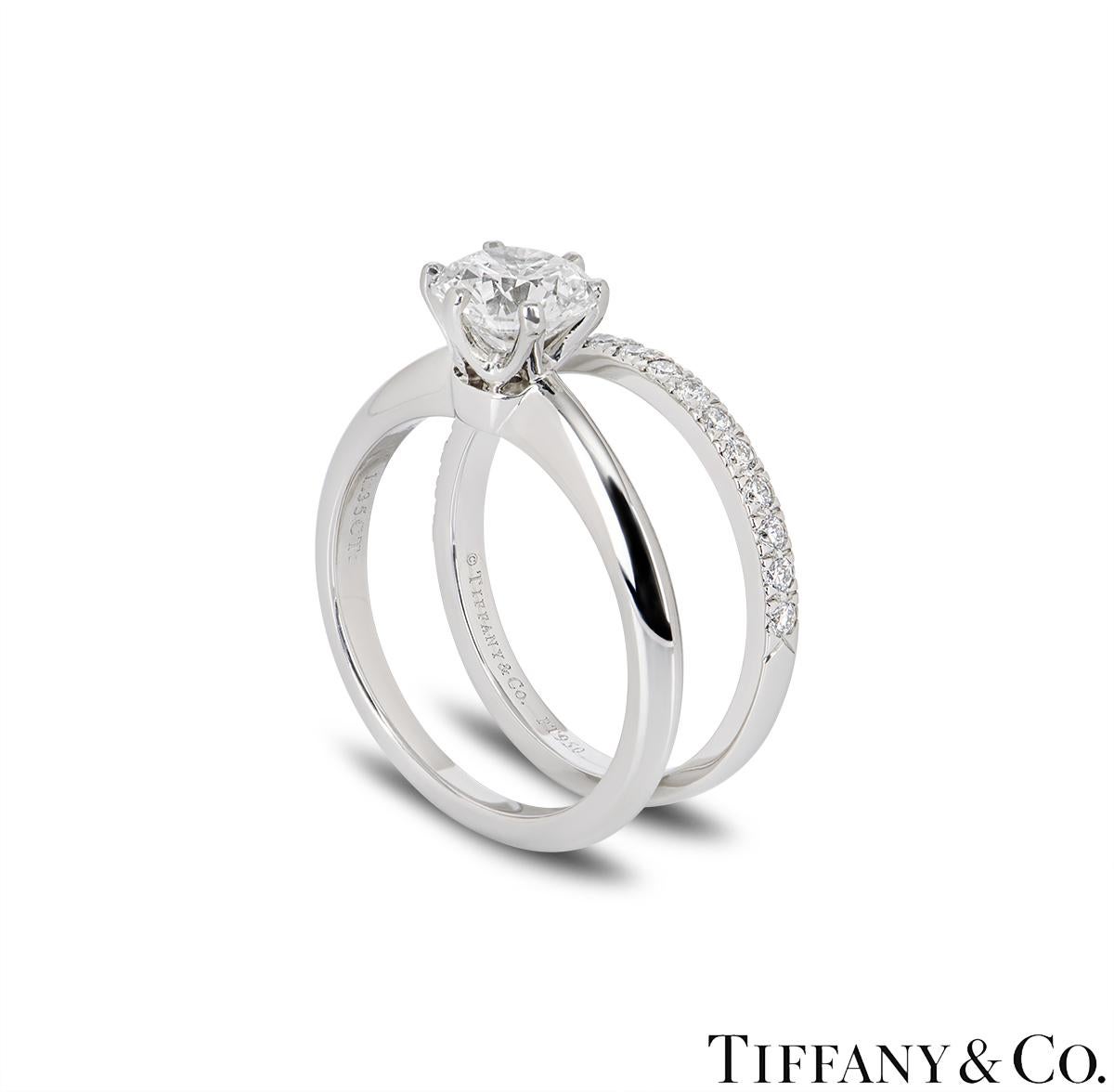 A stunning platinum Tiffany & Co. diamond ring from the Setting collection. The ring comprises of a round brilliant cut diamond in a 6 claw setting with a weight of 1.35ct, H colour and VS1 clarity. The Setting ring is complemented by a half diamond