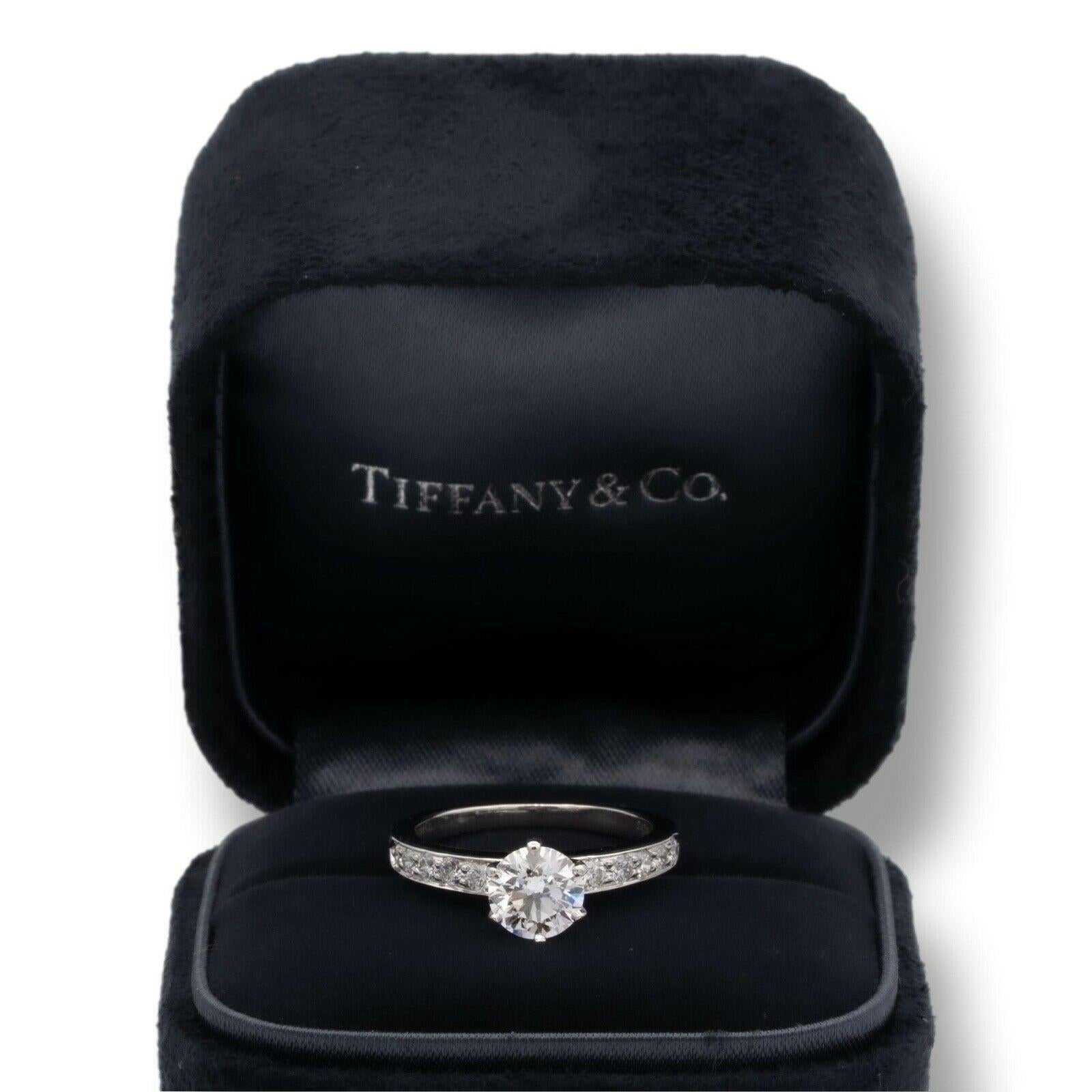 Tiffany & Co. Diamond Engagement ring with channel set diamond band featuring a 0.87 ct center H VVS2 in Platinum. Center diamond is flanked by 5 channel set round brilliant cut diamonds on each side set in prongs inside the channel band for a total