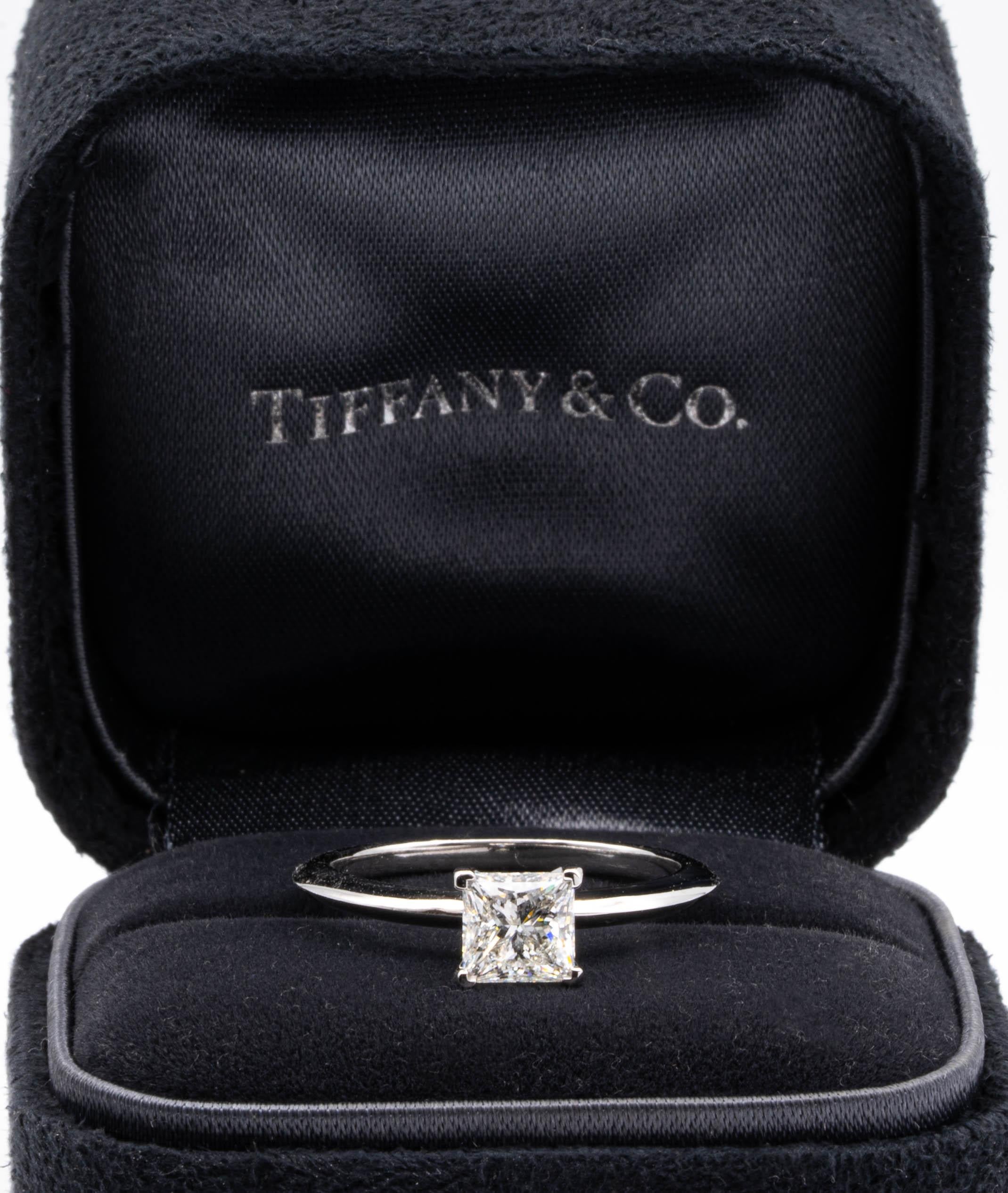 Classic Diamond Engagement Solitaire ring signed by Tiffany & Co. featuring a 4 prong set 0.93 ct Center Princess cut diamond in platinum. Graded by Tiffany I color , and VVS1 Clarity. 
Includes Original Tiffany Certificate and Box 
Current Retail
