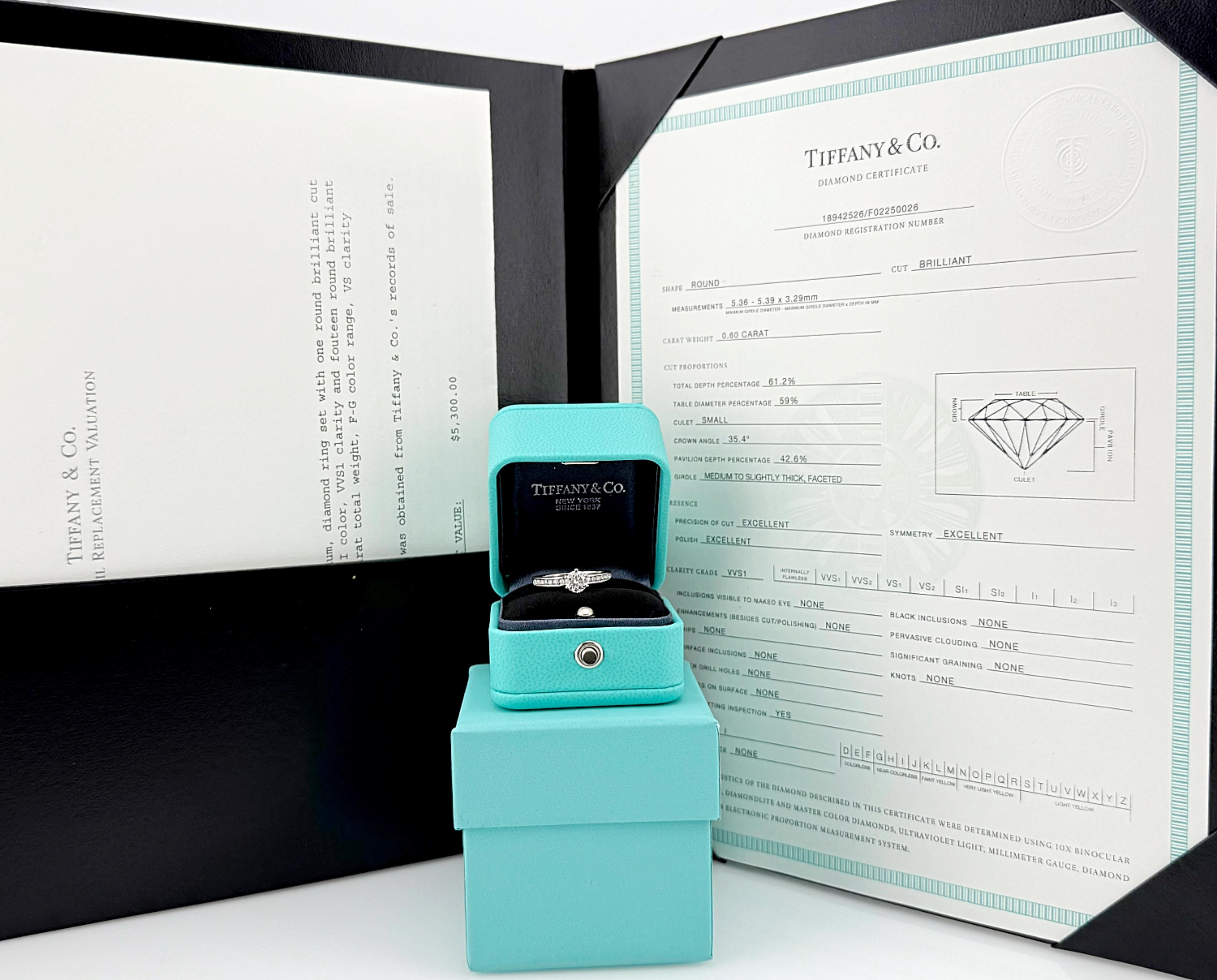 Tiffany & Co. Round Brilliant Diamond with Channel Set Band Engagement Ring
Style:  Solitaire with Accents
Ref. number:  171/17/18942526
Metal:  Platinum PT950
Size:  6.5 sizable
TCW:  0.83 cts
Main Diamond:  Round Brilliant Diamond 0.60 cts 
Color