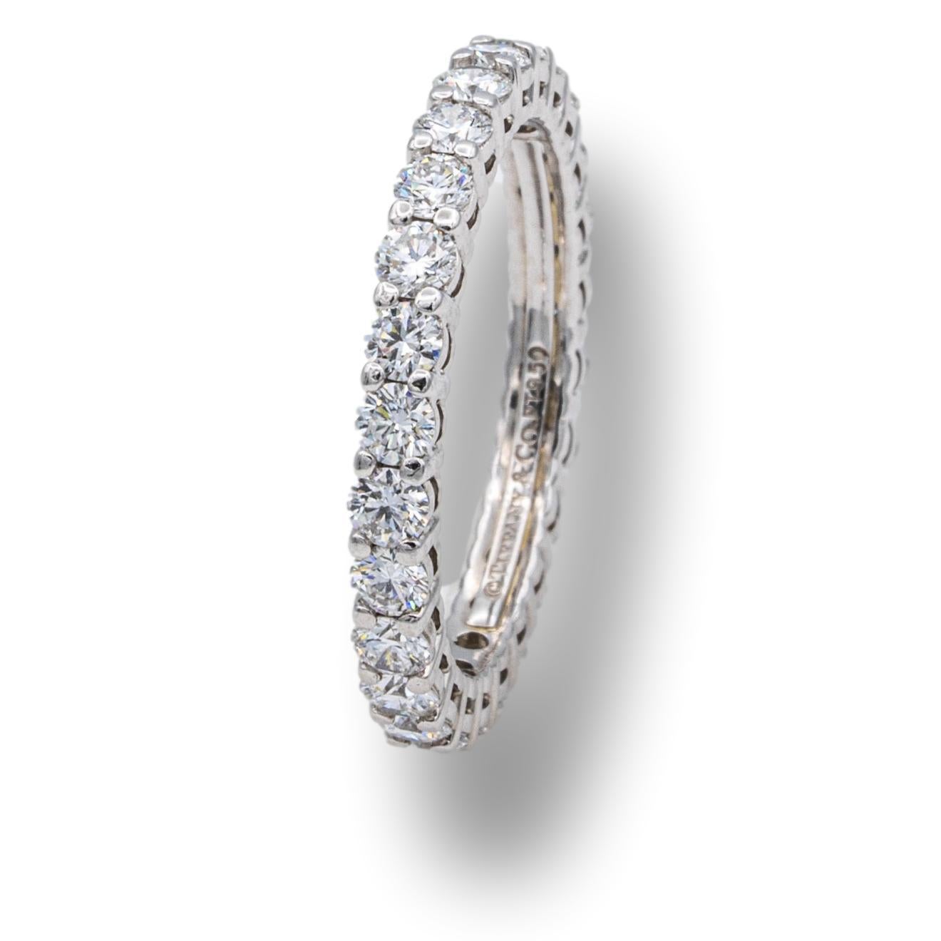 Tiffany & Co. Eternity band from the Embrace collection finely crafted in Platinum with an open gallery and 26 round brilliant cut diamonds set in shared prongs weighing 0.78 carats total weight with an open gallery design. High quality diamonds