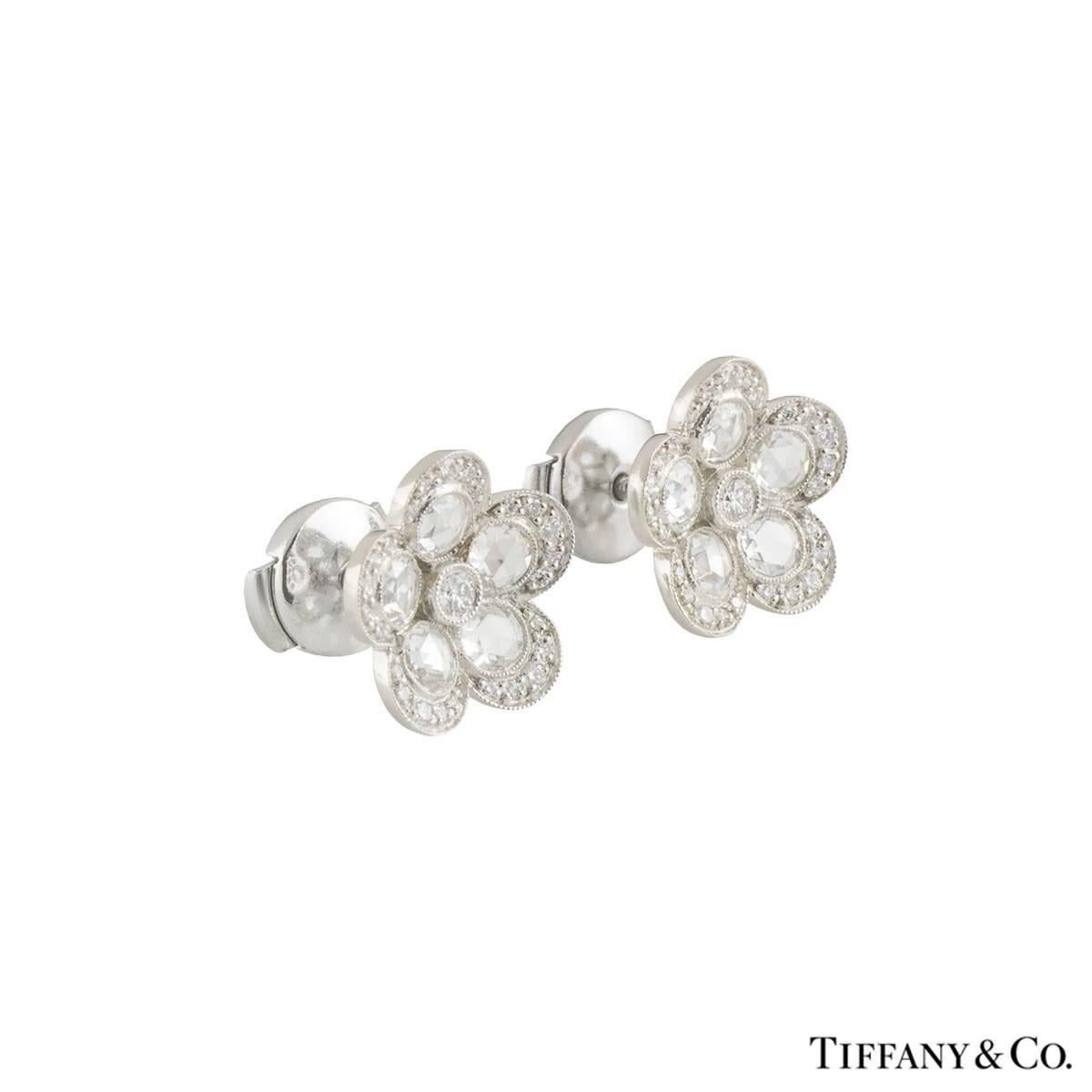 A beautiful pair of platinum diamond Tiffany earrings from the Garden Flower collection. The earrings each comprise of a round brilliant cut diamond as the stigma, 5 round rose cut diamonds as the petals and round brilliant cut diamonds around the