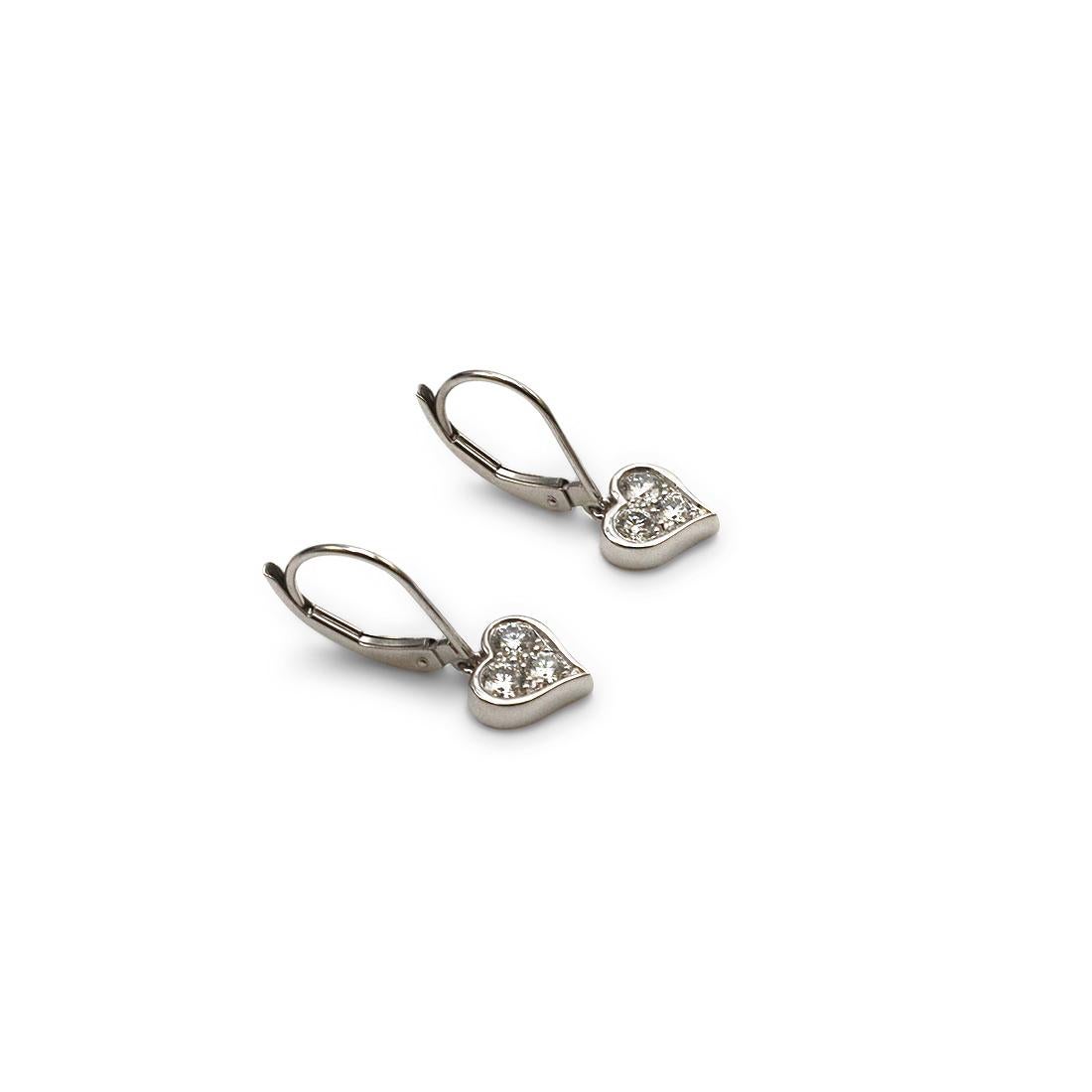 Authentic Tiffany & Co. dangle earrings crafted in platinum features a heart-shaped setting. These lovely earrings are each set with three round brilliant cut diamonds for an estimated 0.25 carats total weight. Signed T&Co., PT950. The earrings are