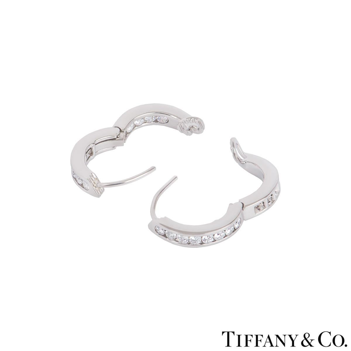 A beautiful pair of platinum diamond hoop earrings by Tiffany & Co. The earrings feature 12 round brilliant cut diamonds set on the outside and inside of the earrings in a channel setting with an approximate total weight of 0.72ct. The earrings