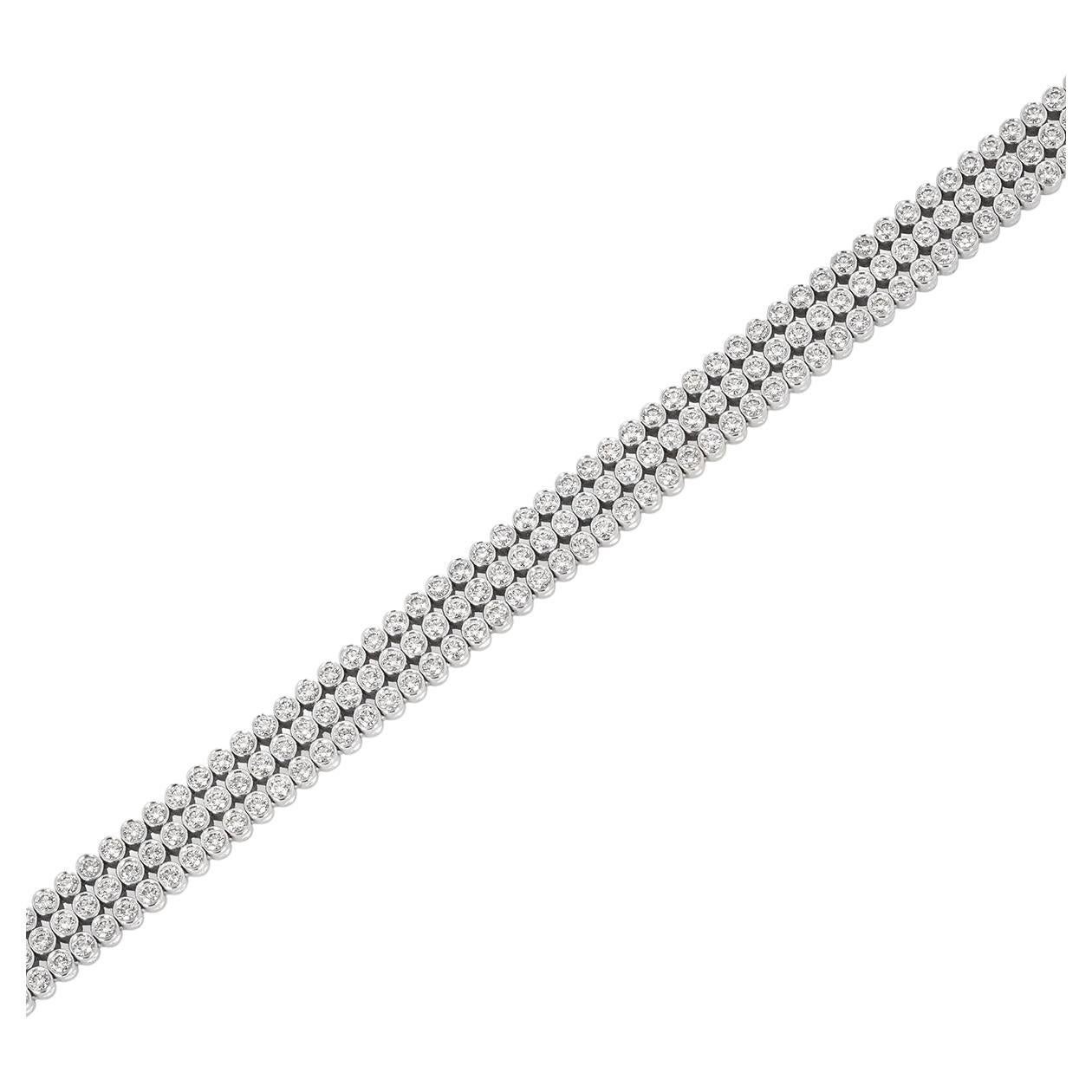 A dazzling platinum diamond line bracelet by Tiffany & Co. from the Jazz collection. The three-row bracelet features 201 round brilliant cut diamonds bezel set throughout with an approximate total weight of 6.03ct, F-G colour and VS clarity. The 7mm