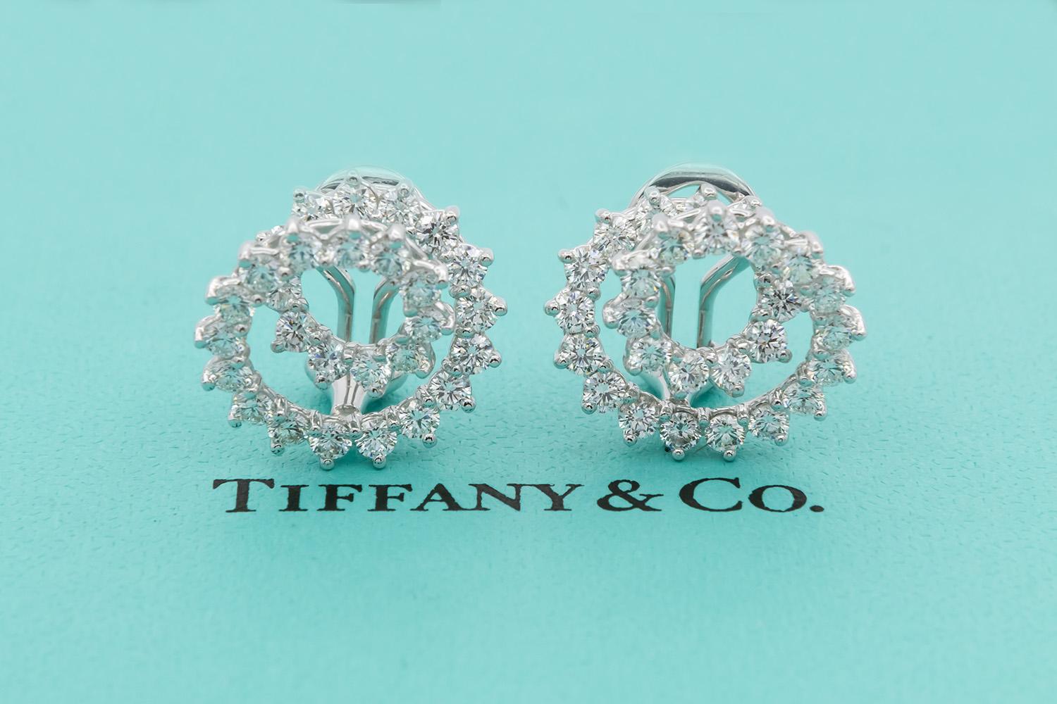 We are pleased to present these Tiffany & Co. Mini Swirl Earrings. These beautiful earrings feature a unique spiral swirl design, set with an estimated 2.54ctw F-G/VS-SI round brilliant cut diamonds and fashioned from platinum with a clip style
