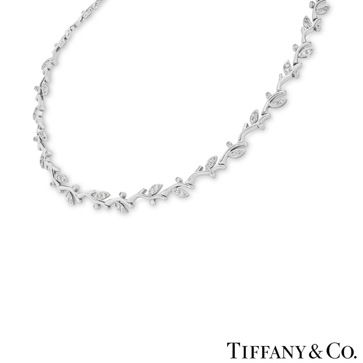 A stunning platinum diamond necklace by Tiffany & Co. from Paloma Picasso's Olive Leaf collection. The collar-style necklace displays a design of leaves on a vine set with 102 round brilliant cut diamonds with an approximate total weight of 2.55ct,