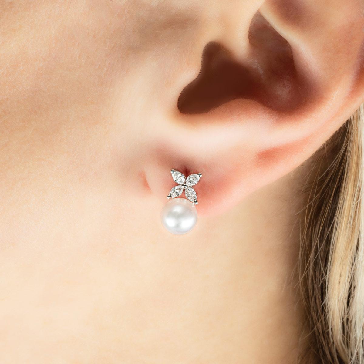 A pair of platinum earrings from the Victoria collection by Tiffany & Co. Each earring is set with 4 marquise cut diamonds in a claw setting with the 8 marquise cut diamonds having a total weight of 0.36ct. The earrings also feature an Akoya