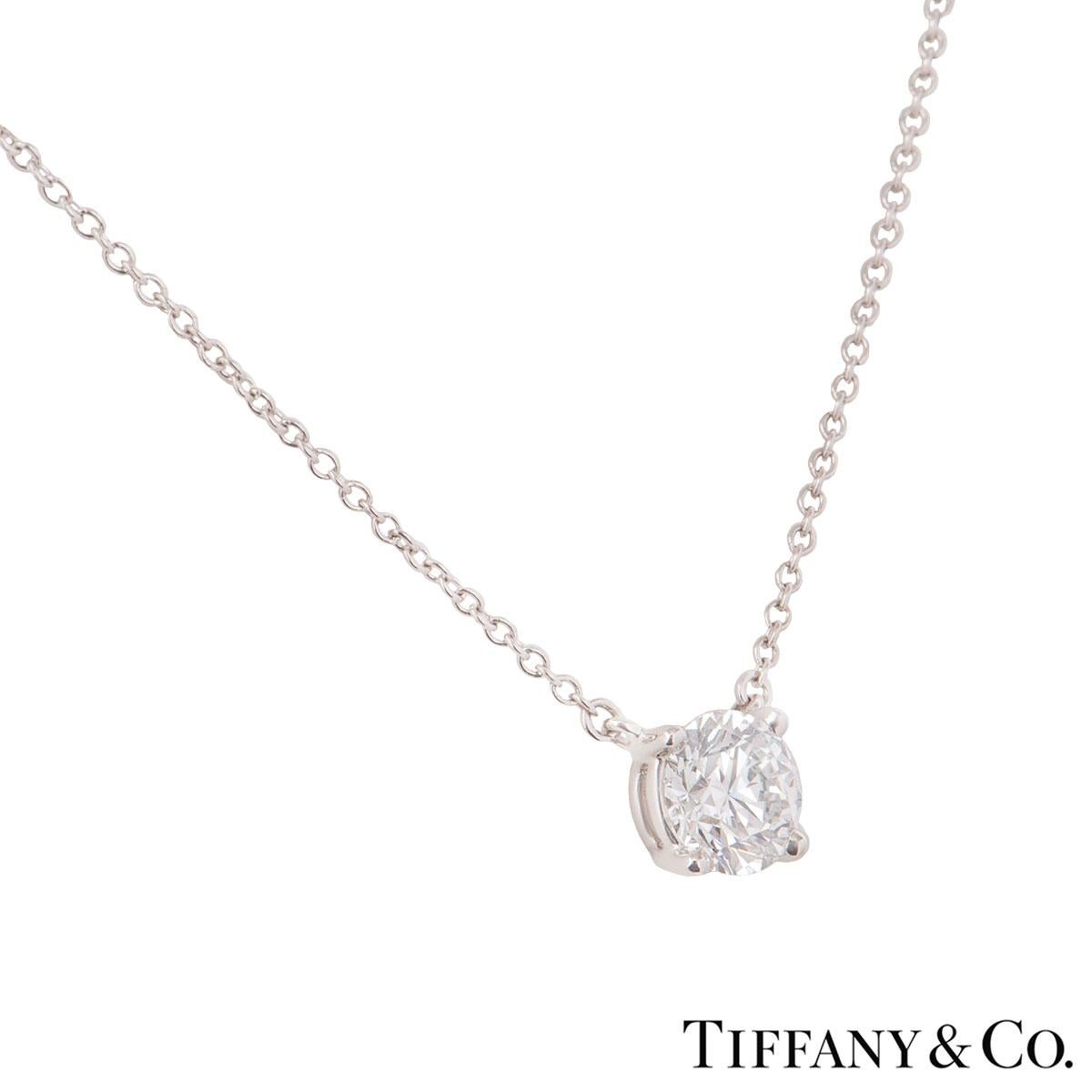 A lovely Tiffany & Co. platinum diamond pendant. The pendant features a single round brilliant cut diamond in a 4 claw setting with a weight of 0.94ct, E colour and VVS2 clarity. The pendant features a 15.80 inch cable chain with a spring clasp and