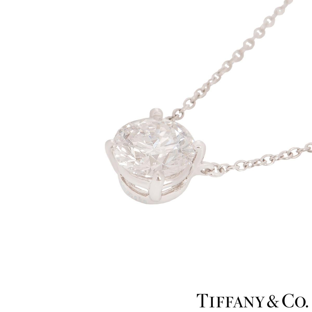 An elegant platinum diamond pendant by Tiffany & Co. The pendant features a single round brilliant cut diamond in a 4 claw setting with a weight of 1.45ct, F colour and VVS2 clarity. The diamond scores an excellent rating in all three aspects for