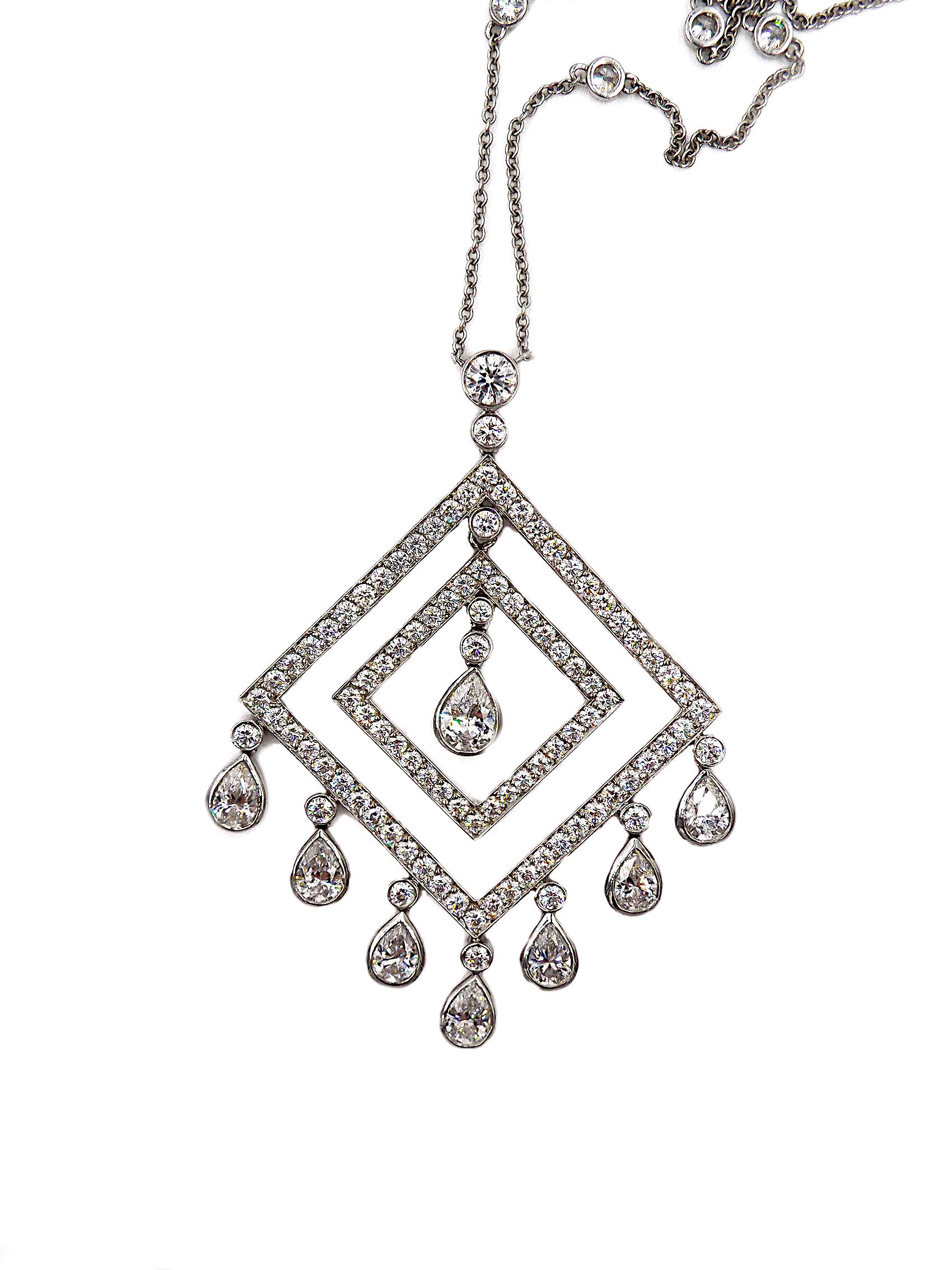 Suspending an articulated openwork circular-cut diamond pendant, with a fringe of pear-shaped diamonds, mounted in platinum, to the fine link neckchain, spaced by collet-set diamonds.
Total diamond weight approx. 8ct
Chain length: 16''
Signed