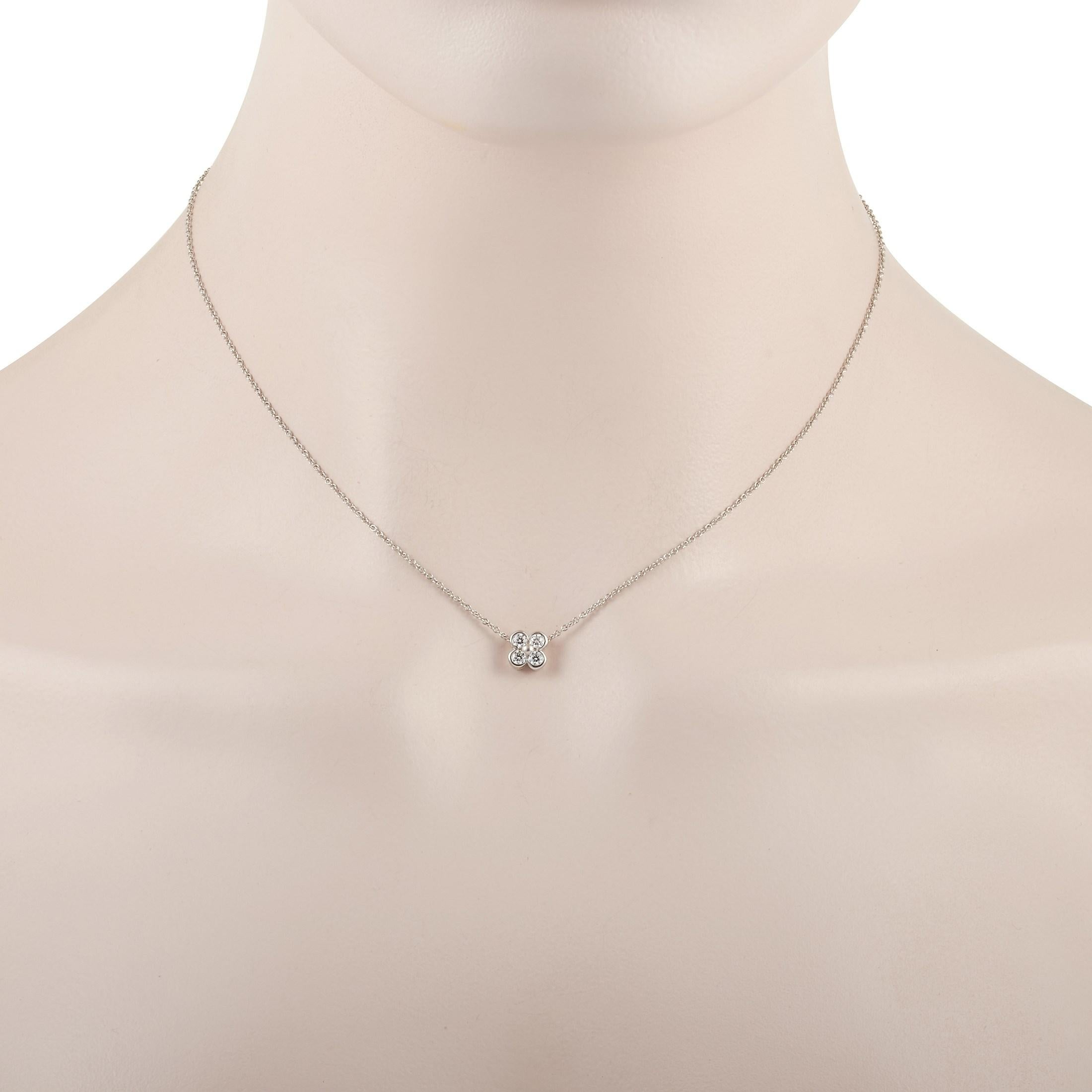 This classic Tiffany & Co. Platinum Diamond necklace is made with Platinum and features four round diamonds that weigh 0.20 carats and are set in a clover-shaped pendant. The fine platinum chain measures 15 inches in length and features a spring