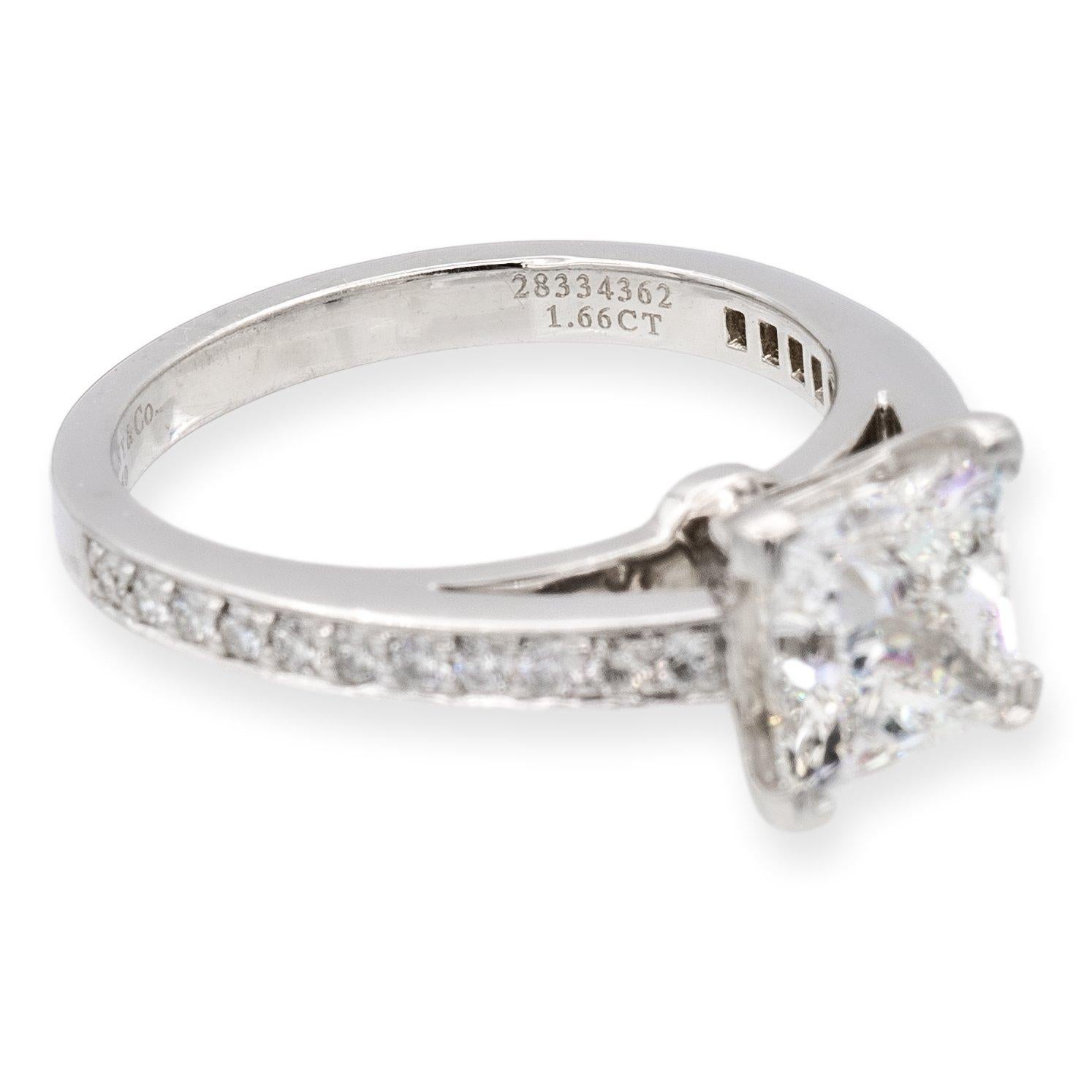 Tiffany & Co. Diamond engagement ring from the Grace collection finely crafted in platinum with an open gallery featuring a square princess cut diamond center weighing 1.66 carats , G color , VVS1 clarity set in a 4 prong basket setting adorned with
