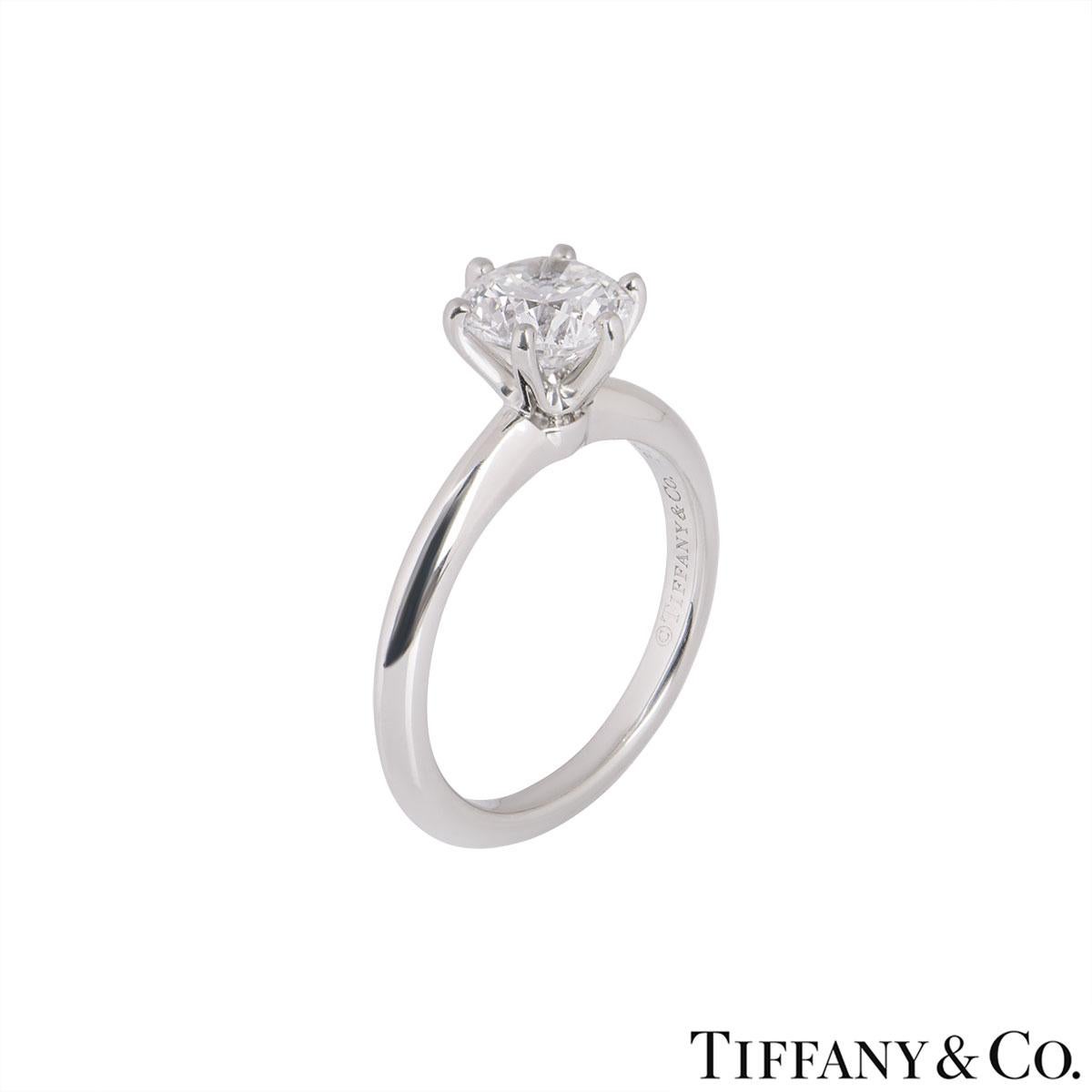 A beautiful platinum diamond ring by Tiffany & Co. from the Setting collection. The ring comprises of a round brilliant cut diamond in a 6 claw setting with a weight of 1.24ct, G colour and VS1 clarity. The diamond scores an excellent rating in all