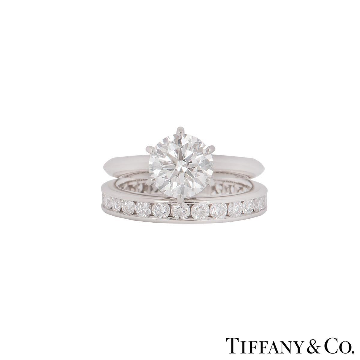 A stunning platinum diamond ring with a full diamond eternity ring by Tiffany & Co. The ring features a round brilliant cut diamond in a 6 claw setting with a weight of 1.61ct, I colour and VS2 clarity.  The diamond scores an excellent rating in all