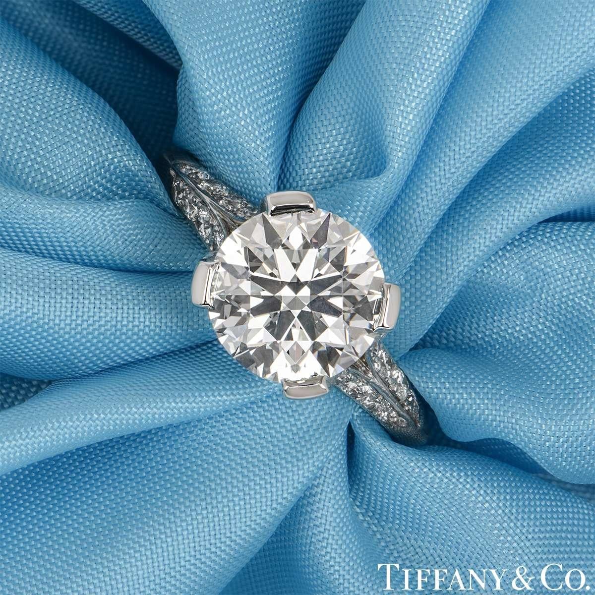 An elegant platinum diamond engagement ring by Tiffany & Co. The ring is set to the centre with a 2.23ct round brilliant diamond in a 4 claw setting. The diamond is G colour, VVS1 clarity and scores an excellent rating in all three aspects for cut,