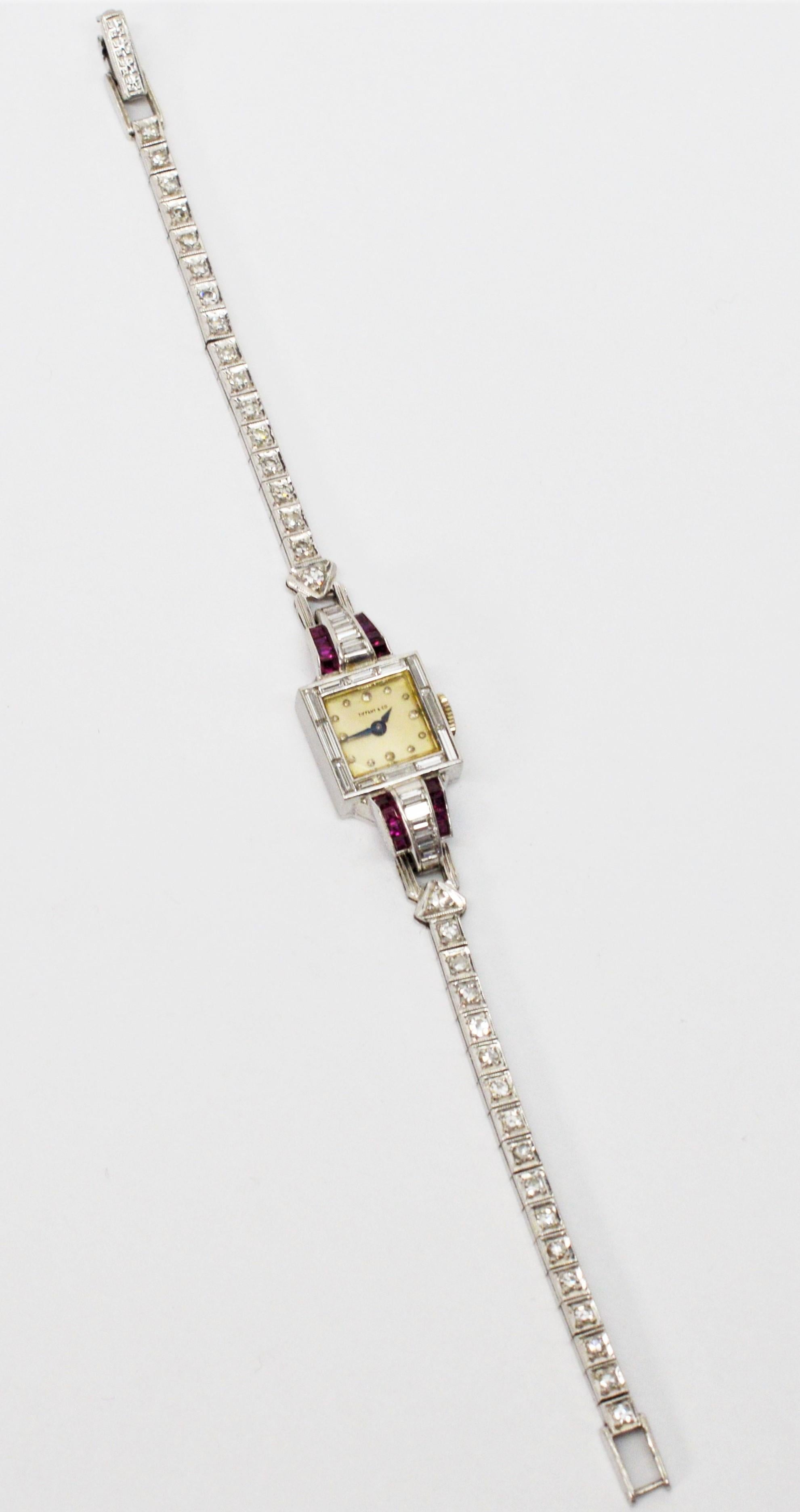 Diamonds set in platinum adorn the elegant bracelet of this Tiffany & Co. ladies Art Deco wrist watch.  Ultra feminine profile with it's slender geometric styling of the period, the 13.5 mm square watch head is flanked by diamond and ruby baguettes