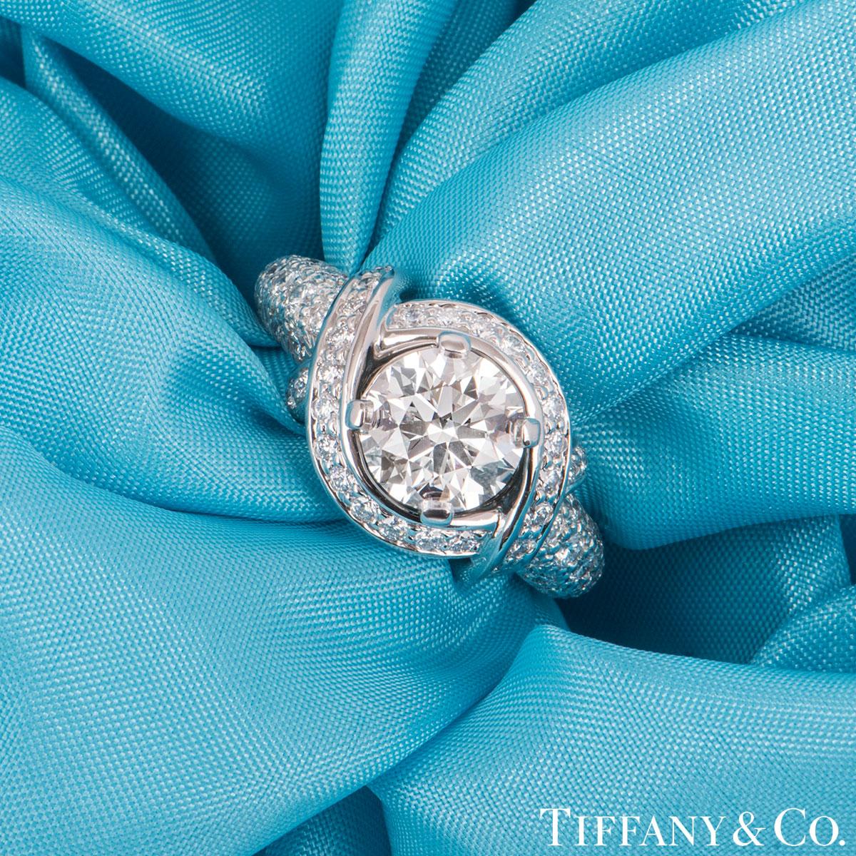 A beautiful platinum diamond Tiffany & Co. ring from the Schlumberger collection. The ring comprises of a round brilliant cut diamond in a 4 claw setting with a weight of 1.55ct, G colour and VVS2 clarity. The ring features approximately 90 round