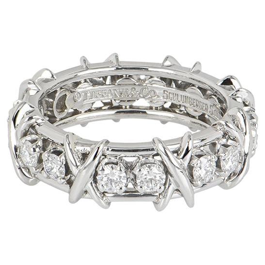 A dazzling platinum diamond ring from the Schlumberger collection by Tiffany & Co. The ring is set with 16 round brilliant cut diamonds totalling 1.14ct, predominantly F colour and VS clarity. The diamonds are each individually claw set and