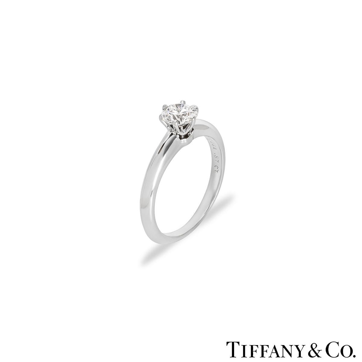 A stunning platinum diamond solitaire ring by Tiffany & Co. from the Setting collection. The solitaire features a round brilliant cut diamond set to the centre in a 6 claw mount weighing 0.57ct, D colour and VVS2 clarity. The 2mm knife edge ring has