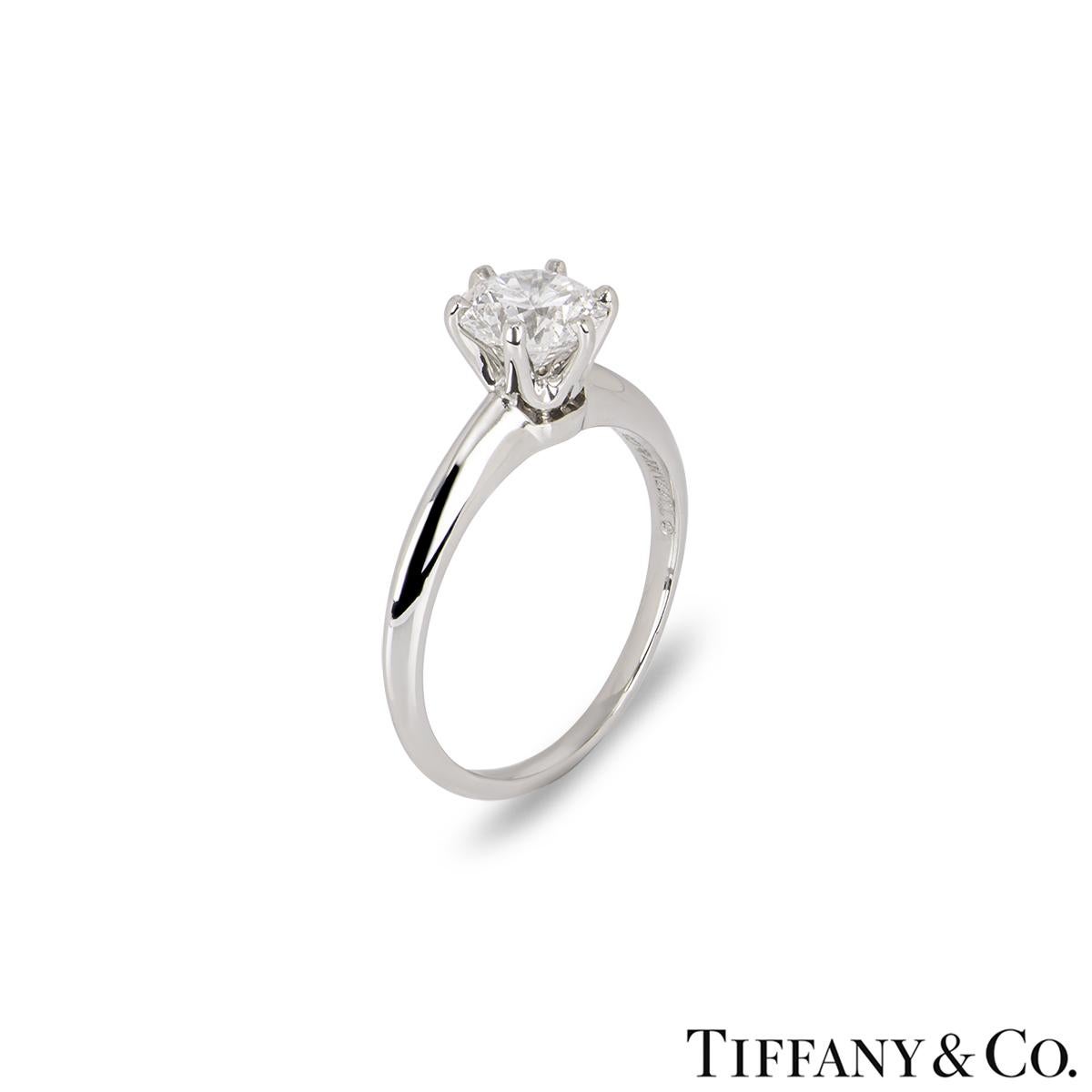 A stunning platinum diamond solitaire ring by Tiffany & Co. from the Setting collection. The solitaire features a round brilliant cut diamond set to the centre in a 6 claw mount weighing 1.11ct, D colour and VS1 clarity. The diamond scores an