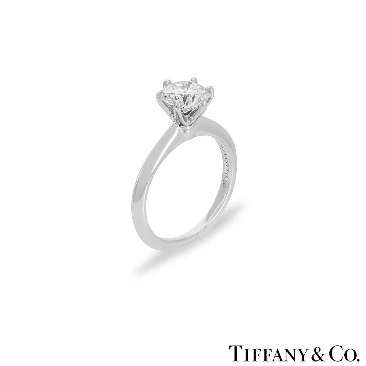 A beautiful platinum diamond ring by Tiffany & Co. from the Setting collection. The ring comprises of a round brilliant cut diamond in a 6 claw setting with a weight of 1.08ct, I colour and VS1 clarity. The diamond scores an excellent rating in all