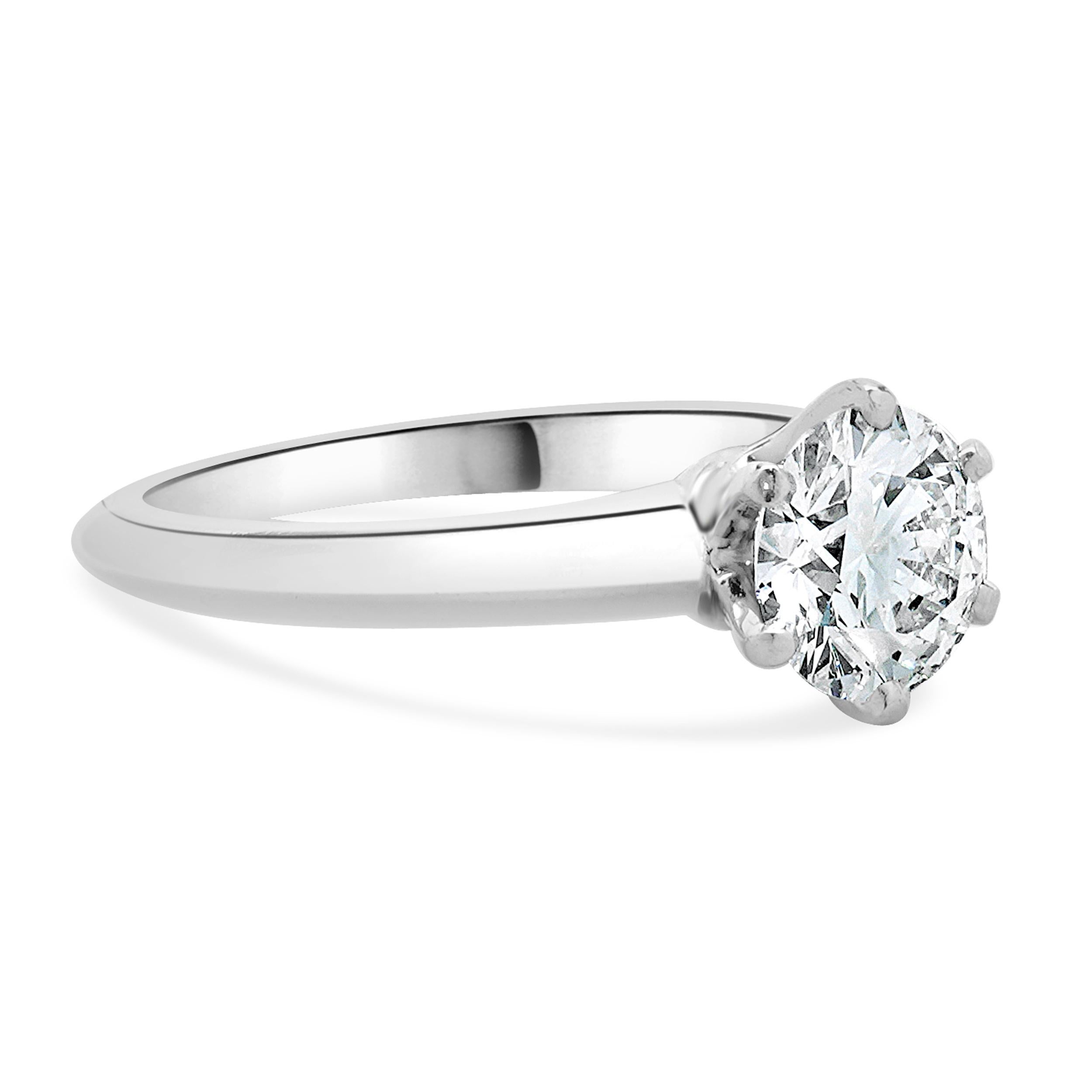 Designer: Tiffany & Co. 
Material: platinum
Diamond: 1 round brilliant = 1.14ct
Color: D
Clarity: VS1
GIA: 11502839
T & Co. Cert # 17002856/C10030192
Dimensions: ring top measures 2.8mm wide
Weight: 5.10 grams
Size: 5.75 complimentary sizing