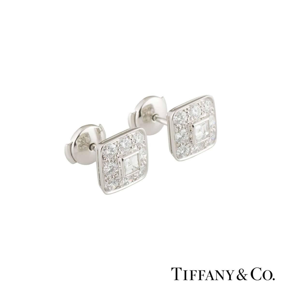 A beautiful pair of platinum diamond Tiffany & Co. earrings. The earrings each comprises of an asscher cut diamond set to the centre in a rubover setting with 8 round brilliant cut diamonds in a pave setting. The diamonds have a total approximate