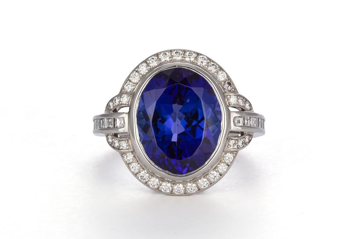 We are pleased to offer this Authentic Tiffany & Co. Platinum, Diamond and Tanzanite Cocktail Ring. This stunning blue and violet stone was discovered in Tanzania in the late 1960's and can only be found there. Tiffany & Co dubbed this gorgeous