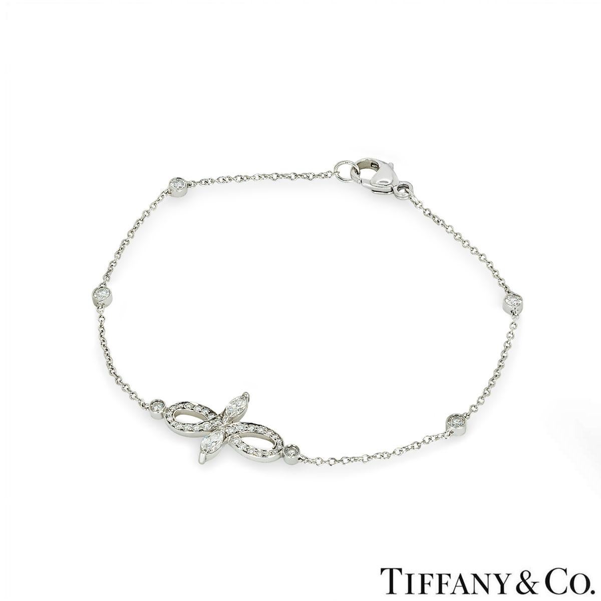 A beautiful 18k white gold Tiffany & Co. diamond bracelet from the Victoria collection. The bracelet comprises of an open work design with 2 marquise cut diamonds at each end with a total weight of 0.13ct, F colour and VS+ clarity. Complementing the