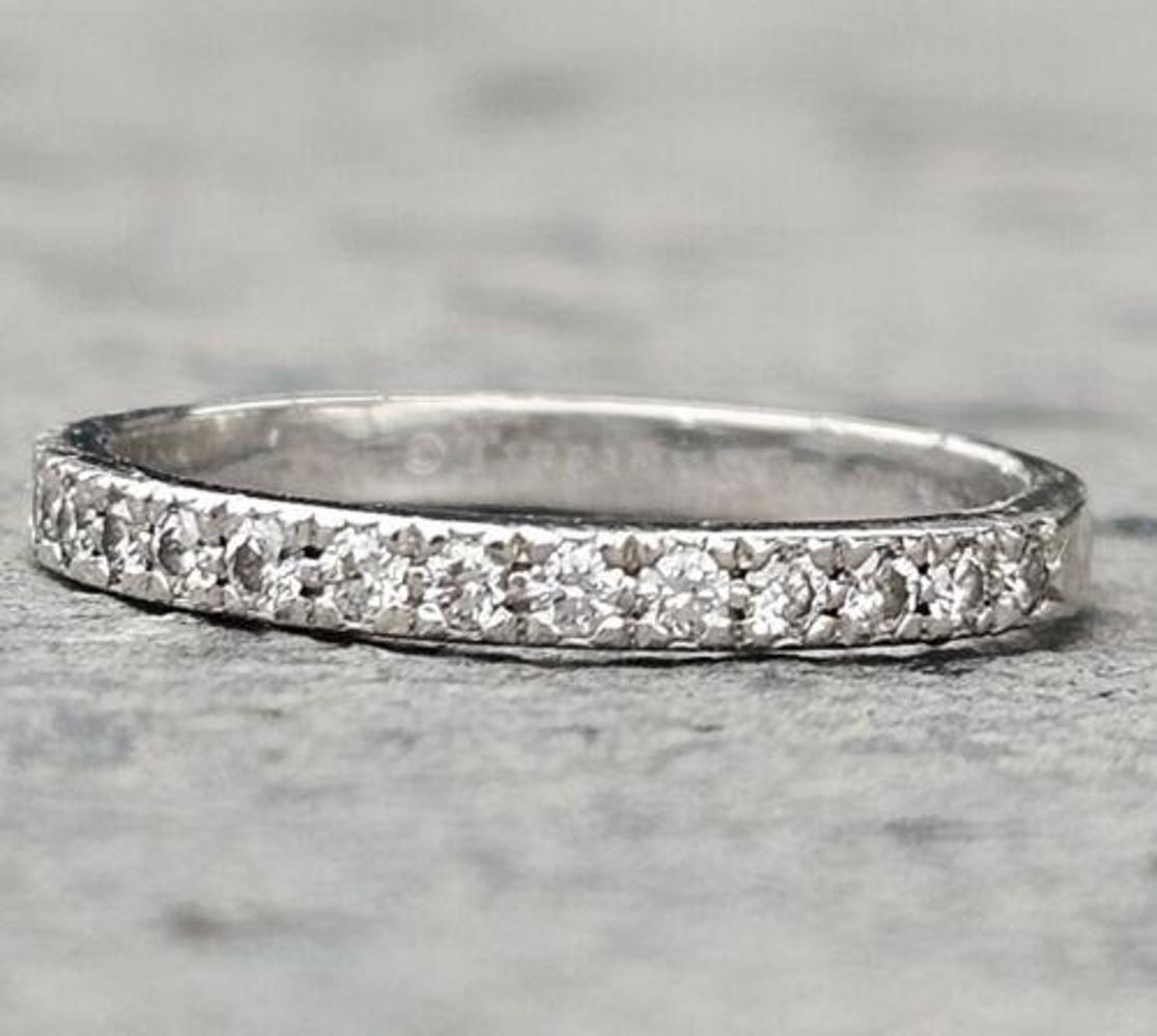 This exquisite Tiffany & Co. wedding band ring is the perfect symbol of your eternal love. Crafted from pure platinum, this ring features stunning diamonds that captures the light beautifully. The ring size is 5, and it is suitable for any wedding