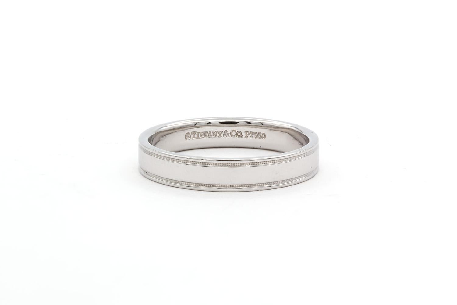 We are pleased to offer this Authentic Tiffany & Co. Platinum Double Milgrain Mens Wedding Band Ring. It features a classic mens Tiffanys band design in .950 Platinum, measuring 4mm wide with double milgrain. It is a size 10.25 US. The ring is in