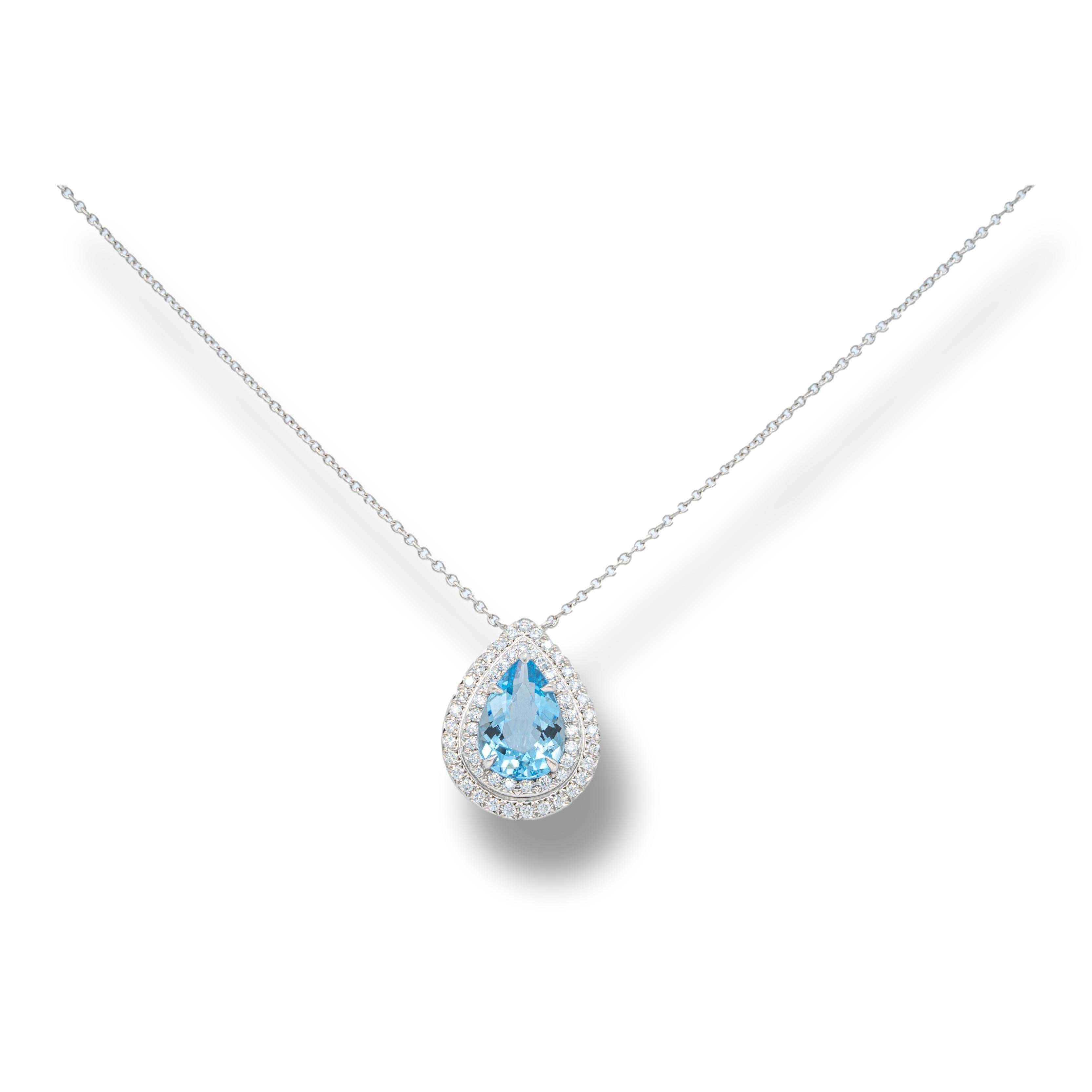 Tiffany & Co. Soleste pendant finely crafted in platinum featuring a 1.25 ct pear shape aquamarine center adorned with a double halo of bead set round brilliant cut diamonds weighing 0.19 carats total weight hanging off a 16