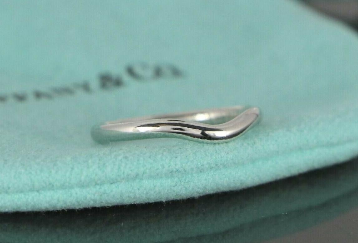 Brand Tiffany & co 
Mint condition 
Occasion wedding
Material PT950 
Ring Size 6.25
weight 3.6 
Ring width 2mm
Length 20mm 
Comes with Tiffany & co ring box