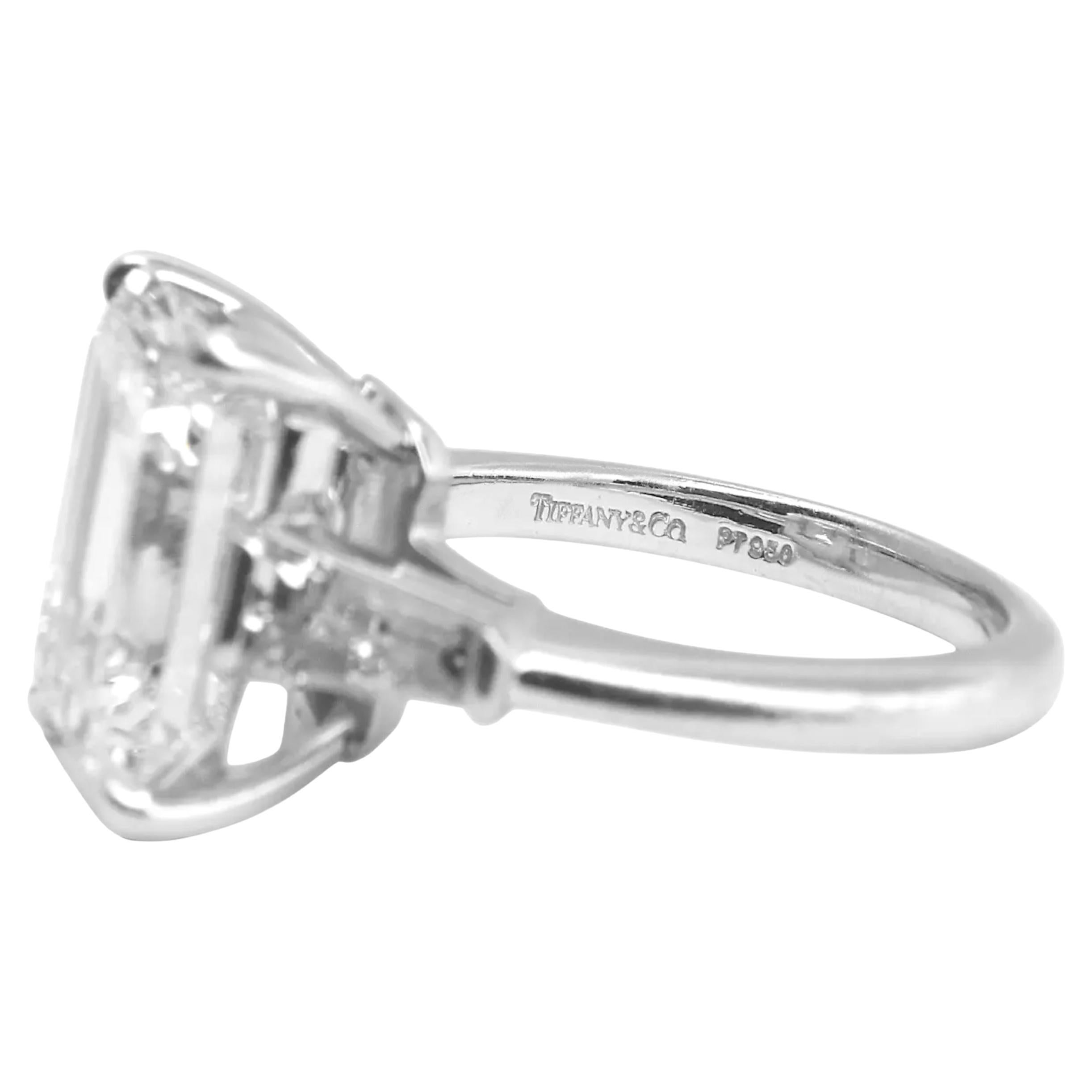 Tiffany & Co. Platinum Emerald Cut Diamond Ring – 6.05 Carats

A timeless masterpiece from Tiffany & Co., this exquisite ring is crafted in luxurious 950 platinum and showcases a striking emerald-cut diamond flanked by elegant tapered baguette side
