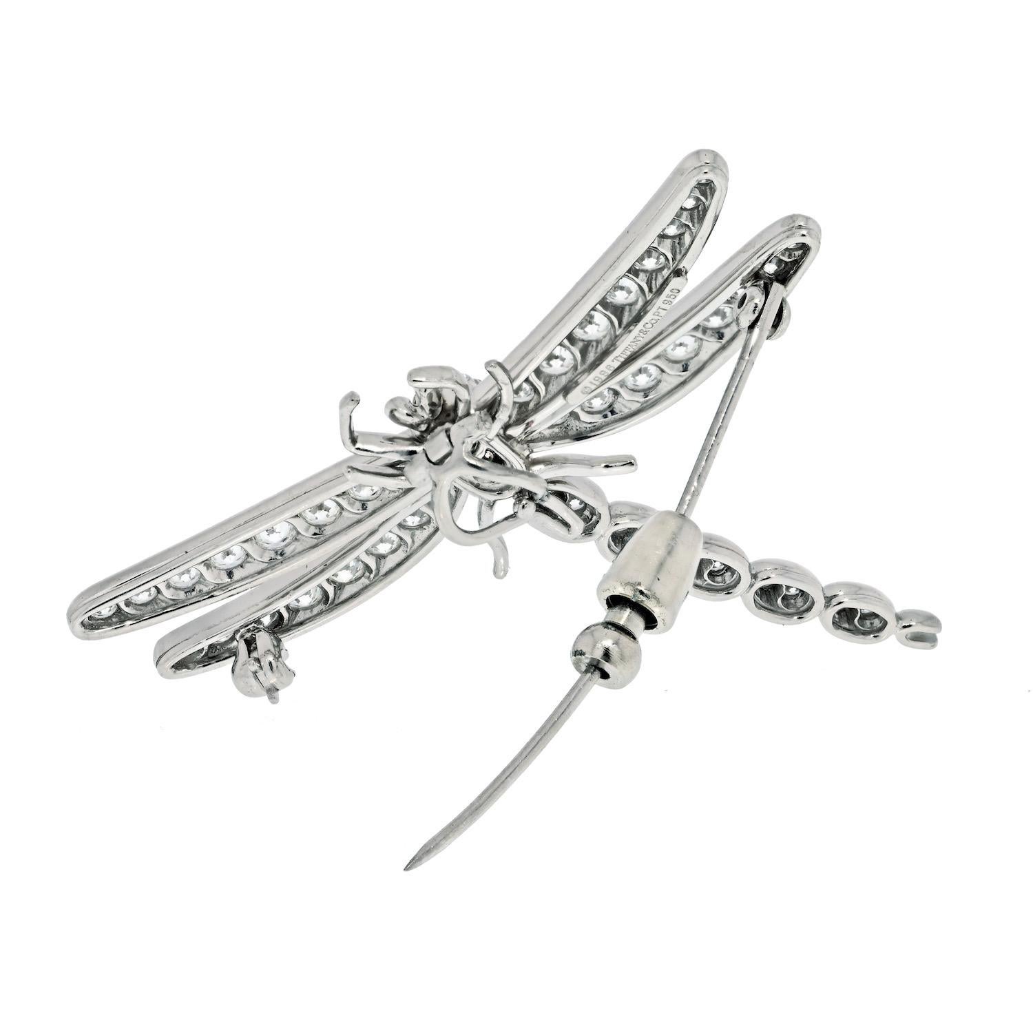 This whimsical pendant brooch is crafted on platinum with pave set round cut diamonds of highest quality. The delicate dragonfly has eye made of gemstones and brilliant cut diamonds on the wings and body. 
Diamonds: 43 round brilliants with