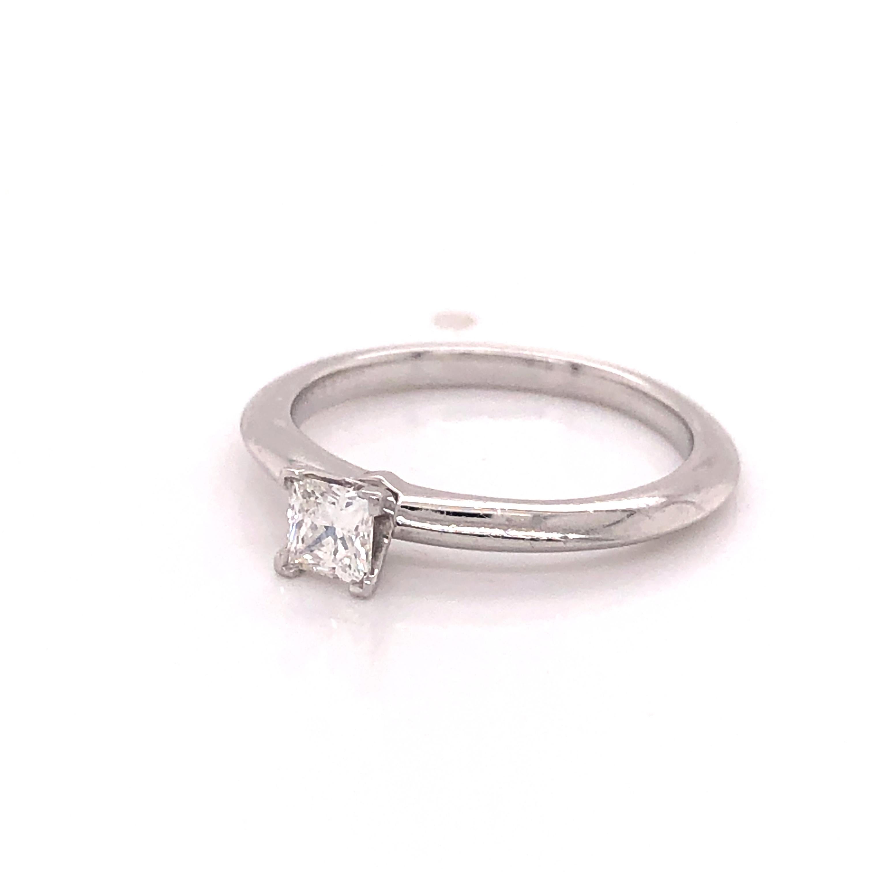 Gorgeous and simple design from famed designer Tiffany & Co. The ring is crafted in platinum and this solitaire style ring holds a 0.23 ct princess cut diamond. The diamond measures 3.50 x 3.49 x 2.37 mm (L,W,D). The stone weighs .23 carat and is a