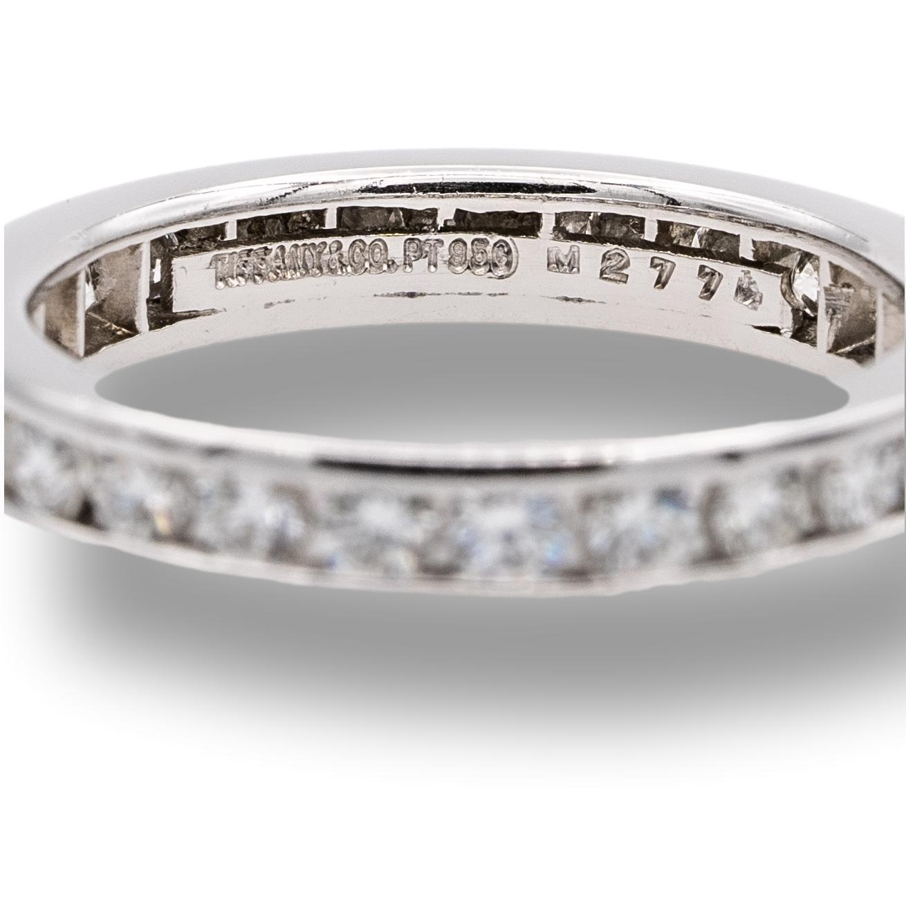Tiffany & Co. wedding band finely crafted in platinum with 25 round brilliant cut diamonds weighing 0.93 carats total weight approximately set all the way around in a channel setting. The ring is 3mm wide. 

Brand: Tiffany & Co.

Hallmarks: Tiffany