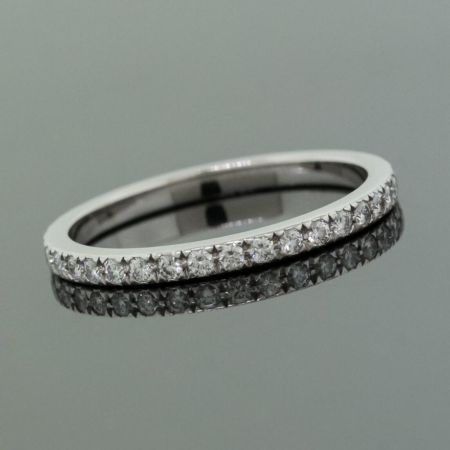 TIFFANY & Co. Platinum Full Circle Diamond Novo Band Ring 6

Metal: Platinum
Size: 6
Band width: 2mm
Diamond: round brilliant diamonds, carat total weight .36 
Hallmark: ©TIFFANY&CO. PT950
Condition: Excellent condition, like new, comes with Tiffany